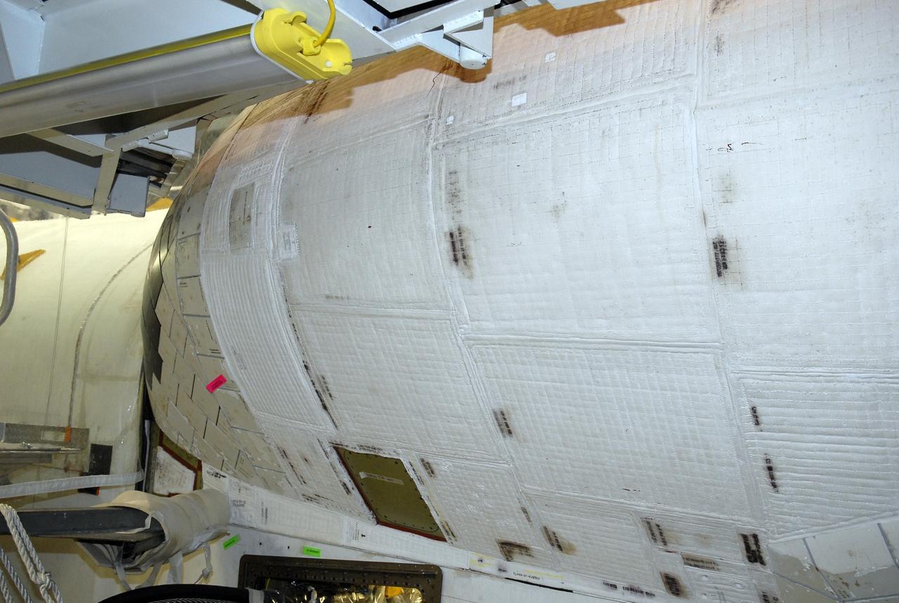 KENNEDY SPACE CENTER, FLA. --  Another view of the area of orbiter Endeavour's orbital maneuvering system, or OMS, pod where the tear occurred on Atlantis during launch of mission STS-117 on June 8, 2007.  Repair is under consideration following testing at KSC and Houston. The test articles each feature three tiles (Low Temperature Reusable Surface Insulation, or LRSI) affixed next to two FIB blankets, simulating the thermal protection system set-up on Atlantis' OMS pod in the vicinity of the in-flight anomaly.  These test articles were flown to Texas the morning of June 14.  The TPS team at KSC has also provided a total of 22 FIB samples for other testing and analysis.   Photo credit: NASA/Kim Shiflett