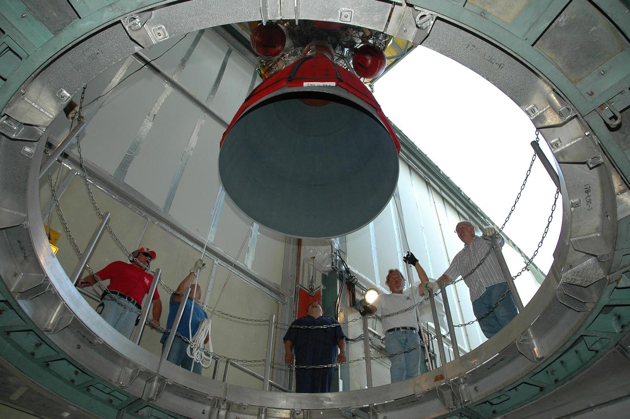 KENNEDY SPACE CENTER, FLA. --  On Launch Pad 17-B at Cape Canaveral Air Force Station, the second stage of the Delta II launch vehicle for the Dawn spacecraft is lowered into the hole toward the Delta first stage below.  The two stages will be mated. The Delta II-Heavy, manufactured by the United Launch Alliance, is scheduled to launch the Dawn spacecraft on its 4-year flight to the asteroid belt.  The Delta II-Heavy is the strongest rocket in the Delta II class. It will use three stages and nine solid-fueled booster rockets to propel Dawn on its way. A 9.5-foot payload fairing will protect the spacecraft from the heat and stresses of launch. Dawn's goal is to characterize the conditions and processes of the solar system's earliest epoch by investigating in detail the largest protoplanets that have remained intact since their formations: asteroid Vesta and the dwarf planet Ceres.  They reside in the extensive zone between Mars and Jupiter together with many other smaller bodies, called the asteroid belt.  Dawn is scheduled to launch July 7.  Photo credit: NASA/Jack Pfaller