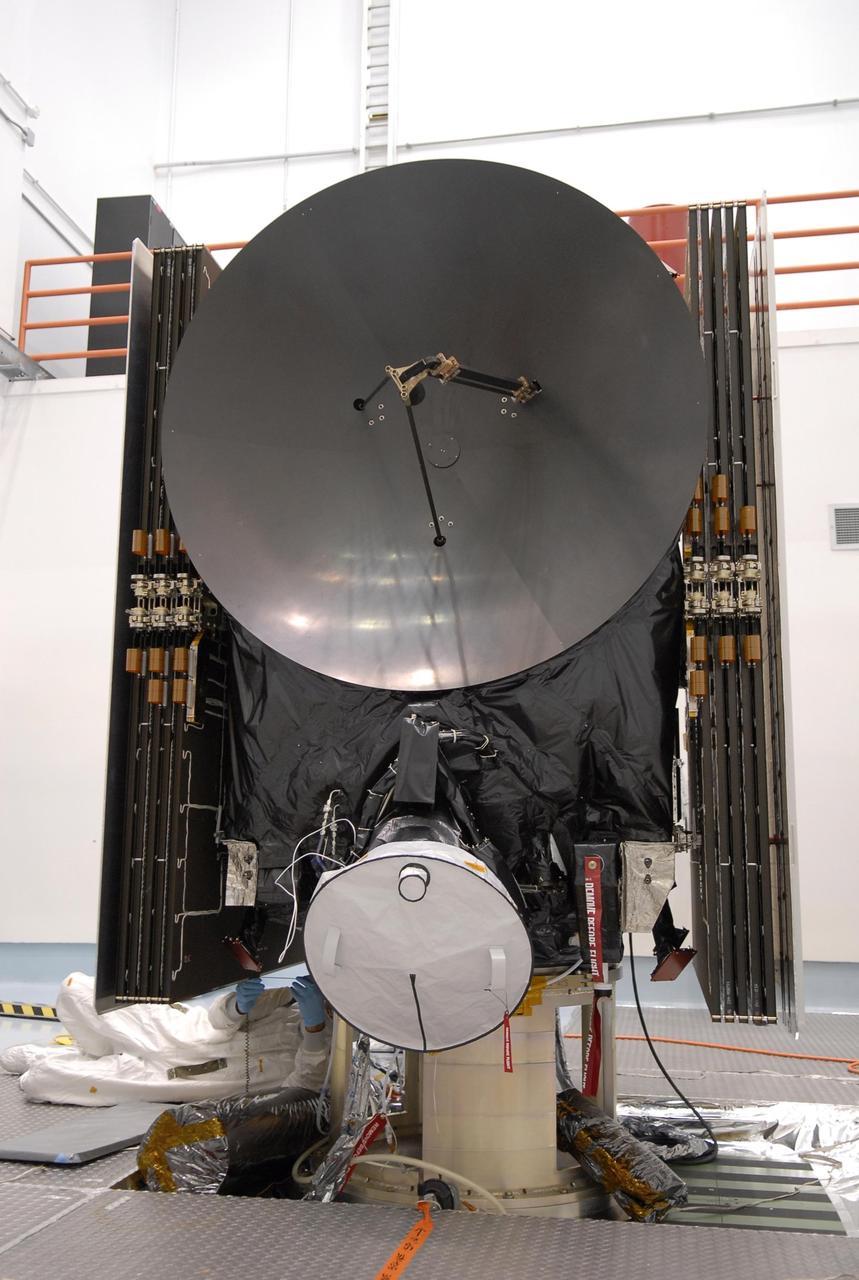 KENNEDY SPACE CENTER, FLA. -- A technicians from Dutch Space gets underneath the solar array panel on the Dawn spacecraft to look at the slight damage done by a technician's tool June 11 during a procedure to prepare Dawn for spin-balance testing. Dawn's goal is to characterize the conditions and processes of the solar system's earliest epoch by investigating in detail the largest protoplanets that have remained intact since their formations: asteroid Vesta and the dwarf planet Ceres. They reside in the extensive zone between Mars and Jupiter together with many other smaller bodies, called the asteroid belt. Dawn is scheduled to launch July 7. Photo credit: NASA/Kim Shiflett