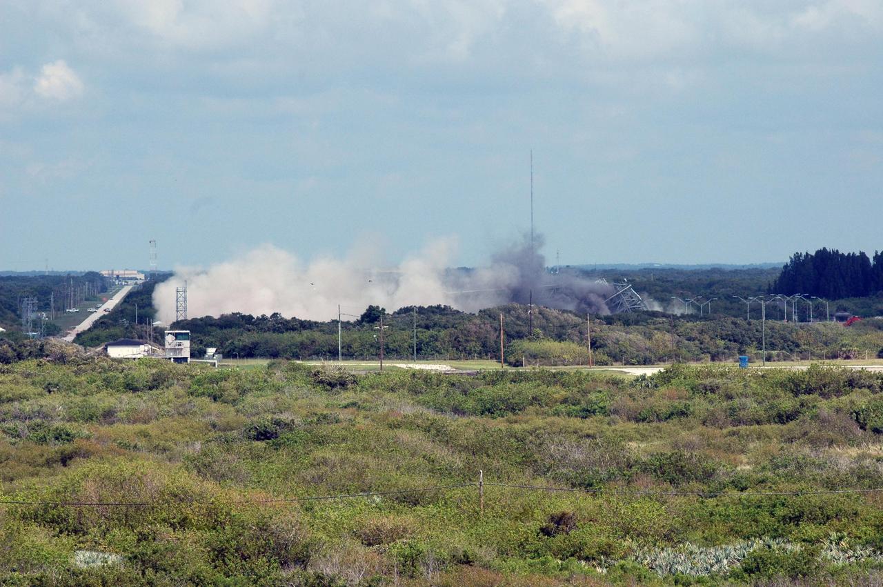 KENNEDY SPACE CENTER, FLA. --  The destruction of the 209-foot-tall mobile service tower on Pad 39-B at Space Launch Complex 36 on Cape Canaveral Air Force Station kicks up a wall of dust.  The tower is one of two that were identified for demolition. The old towers are being toppled as part of the ongoing project to demolish the historic site to prevent corrosion from becoming a safety concern.   A majority of the steel will be recycled and the rest will be taken to the landfill at CCAFS.  Complex 36 was the birthplace of NASA's planetary launch program.  It was built for the Atlas/Centaur development program and was operated under NASA's sponsorship until the late 1980s. Complex 36 hosted many historic missions over the years including Surveyor that landed on the moon and Mariner that orbited Mars and included one to Mercury.  Two of the most historic launches were the Pioneer 10 and 11 space probes that were launched to Jupiter and are now outside of the solar system in interstellar space.  Also, the historic Pioneer Venus spacecraft included an orbiter and a set of probes that were dispatched to the surface.  While Launch Complex 36 is gone, the Atlas/Centaur rocket continues to be launched as the Atlas V from Complex 41. Photo credit: NASA/Charisse Nahser