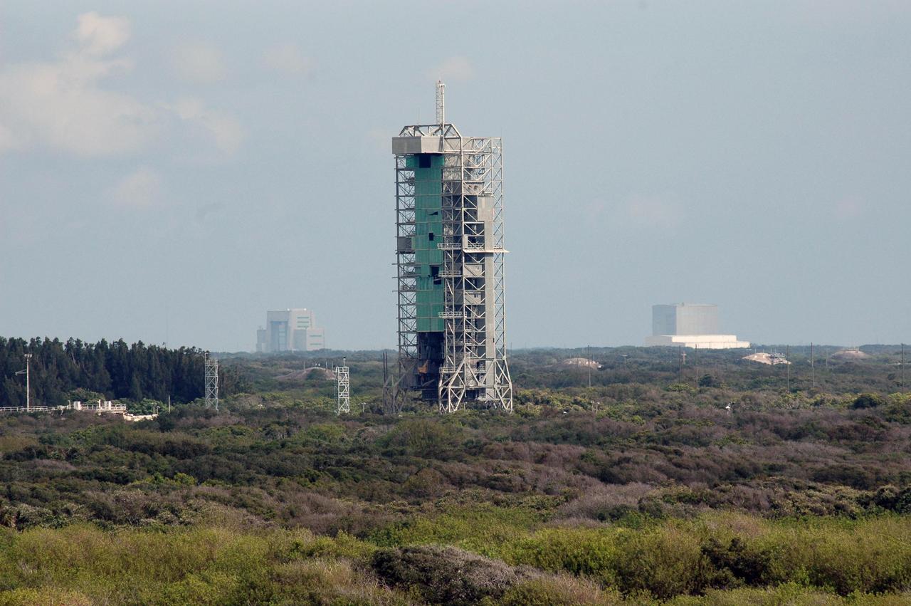 KENNEDY SPACE CENTER, FLA. --  Within sight of the KSC Vehicle Assembly Building (at left on the horizon), the 209-foot-tall mobile service tower on Pad 39-A of Space Launch Complex 36 on Cape Canaveral Air Force Station waits for its demise.  The tower is one of two that were identified for demolition. The old towers are being toppled as part of the ongoing project to demolish the historic site to prevent corrosion from becoming a safety concern.   A majority of the steel will be recycled and the rest will be taken to the landfill at CCAFS.  Complex 36 was the birthplace of NASA's planetary launch program.  It was built for the Atlas/Centaur development program and was operated under NASA's sponsorship until the late 1980s. Complex 36 hosted many historic missions over the years including Surveyor that landed on the moon and Mariner that orbited Mars and included one to Mercury.  Two of the most historic launches were the Pioneer 10 and 11 space probes that were launched to Jupiter and are now outside of the solar system in interstellar space.  Also, the historic Pioneer Venus spacecraft included an orbiter and a set of probes that were dispatched to the surface.  While Launch Complex 36 is gone, the Atlas/Centaur rocket continues to be launched as the Atlas V from Complex 41. Photo credit: NASA/Charisse Nahser