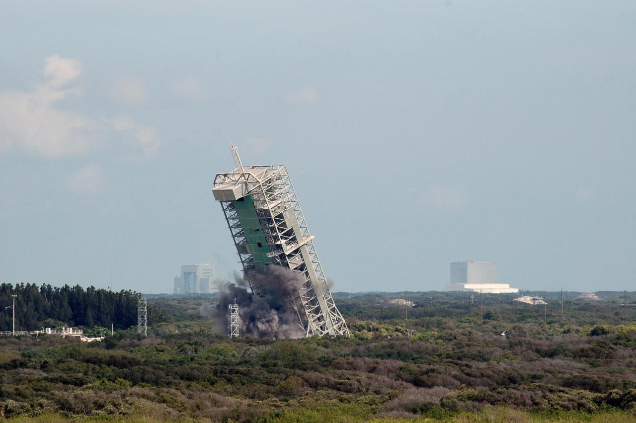 KENNEDY SPACE CENTER, FLA. --   The 209-foot-tall mobile service tower on Pad 39-A of Space Launch Complex 36 on Cape Canaveral Air Force Station careens to the left after 122 pounds of explosives eliminated the base.  The tower is one of two that were identified for demolition. The old towers are being toppled as part of the ongoing project to demolish the historic site to prevent corrosion from becoming a safety concern.   A majority of the steel will be recycled and the rest will be taken to the landfill at CCAFS.  Complex 36 was the birthplace of NASA's planetary launch program.  It was built for the Atlas/Centaur development program and was operated under NASA's sponsorship until the late 1980s. Complex 36 hosted many historic missions over the years including Surveyor that landed on the moon and Mariner that orbited Mars and included one to Mercury.  Two of the most historic launches were the Pioneer 10 and 11 space probes that were launched to Jupiter and are now outside of the solar system in interstellar space.  Also, the historic Pioneer Venus spacecraft included an orbiter and a set of probes that were dispatched to the surface.  While Launch Complex 36 is gone, the Atlas/Centaur rocket continues to be launched as the Atlas V from Complex 41. Photo credit: NASA/Charisse Nahser