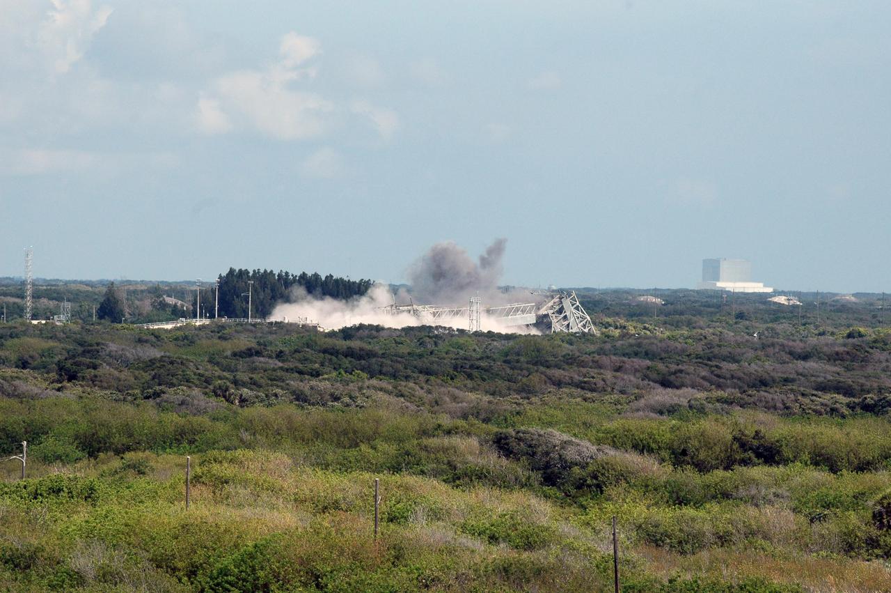 KENNEDY SPACE CENTER, FLA. --   Smoke and dust rising from the ground of Space Launch Complex 36 on Cape Canaveral Air Force Station signifies the destruction of the 209-foot-tall mobile service tower on Pad 39-A.  The tower is one of two that were identified for demolition. The old towers are being toppled as part of the ongoing project to demolish the historic site to prevent corrosion from becoming a safety concern.   A majority of the steel will be recycled and the rest will be taken to the landfill at CCAFS.  Complex 36 was the birthplace of NASA's planetary launch program.  It was built for the Atlas/Centaur development program and was operated under NASA's sponsorship until the late 1980s. Complex 36 hosted many historic missions over the years including Surveyor that landed on the moon and Mariner that orbited Mars and included one to Mercury.  Two of the most historic launches were the Pioneer 10 and 11 space probes that were launched to Jupiter and are now outside of the solar system in interstellar space.  Also, the historic Pioneer Venus spacecraft included an orbiter and a set of probes that were dispatched to the surface.  While Launch Complex 36 is gone, the Atlas/Centaur rocket continues to be launched as the Atlas V from Complex 41. Photo credit: NASA/Charisse Nahser