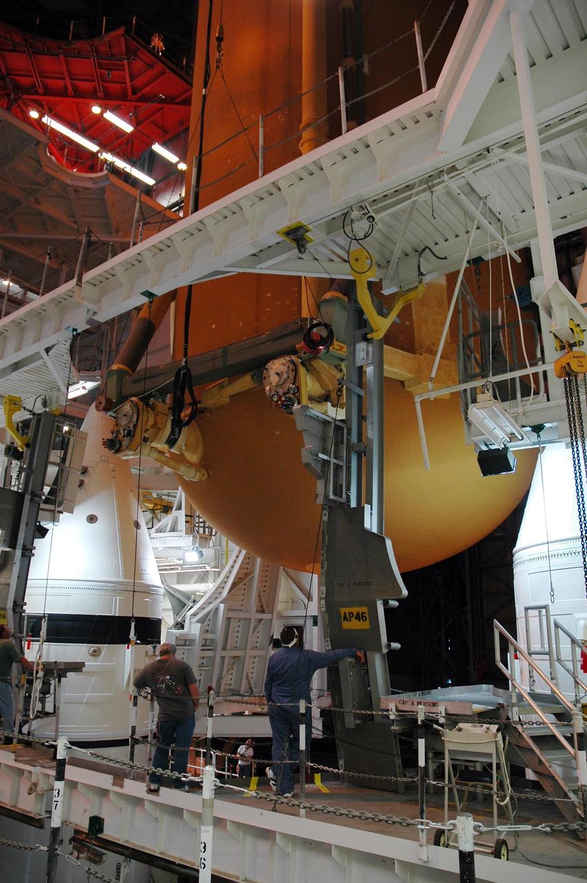 KENNEDY SPACE CENTER, FLA. -- Inside the Vehicle Assembly Building, the external tank for Endeavour is lowered between the solid rocket boosters toward the mobile launcher platform below.  Endeavour is currently  targeted for rollover to the VAB July 5.  Endeavour is the designated orbiter for mission STS-118, targeted for launch on Aug. 9 to the International Space Station. The mission will continue space station construction by delivering a third starboard truss segment, S5, as well as carrying the external stowage platform 3.  Photo credit: NASA/Amanda Diller