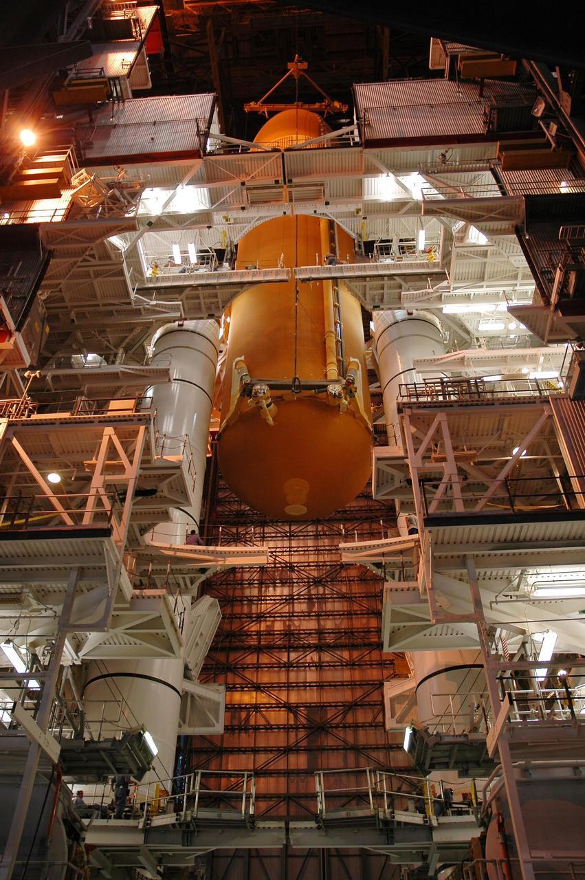 KENNEDY SPACE CENTER, FLA. -- Inside the Vehicle Assembly Building, the external tank for Endeavour is lowered toward the mobile launcher platform for mating with the solid rocket boosters. Endeavour is currently  targeted for rollover to the VAB July 5.  Endeavour is the designated orbiter for mission STS-118, targeted for launch on Aug. 9 to the International Space Station. The mission will continue space station construction by delivering a third starboard truss segment, S5, as well as carrying the external stowage platform 3.  Photo credit: NASA/Amanda Diller