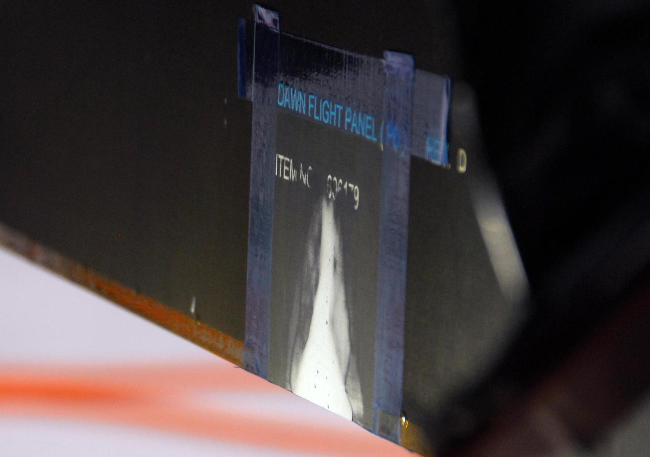 KENNEDY SPACE CENTER, FLA. -- This closeup reveals the repair made to the damage on a solar array panel on the Dawn spacecraft. The damage, incurred on June 11, was made by a technician's tool during a procedure to prepare Dawn for spin-balance testing. The size of the affected area is about 2.5 inches by 2 inches. There was no impact to the launch date of July 7. Dawn's goal is to characterize the conditions and processes of the solar system's earliest epoch 4.5 billion years ago by investigating in detail two of the largest asteroids, Ceres and Vesta. They reside between Mars and Jupiter in the asteroid belt Photo credit: NASA/George Shelton