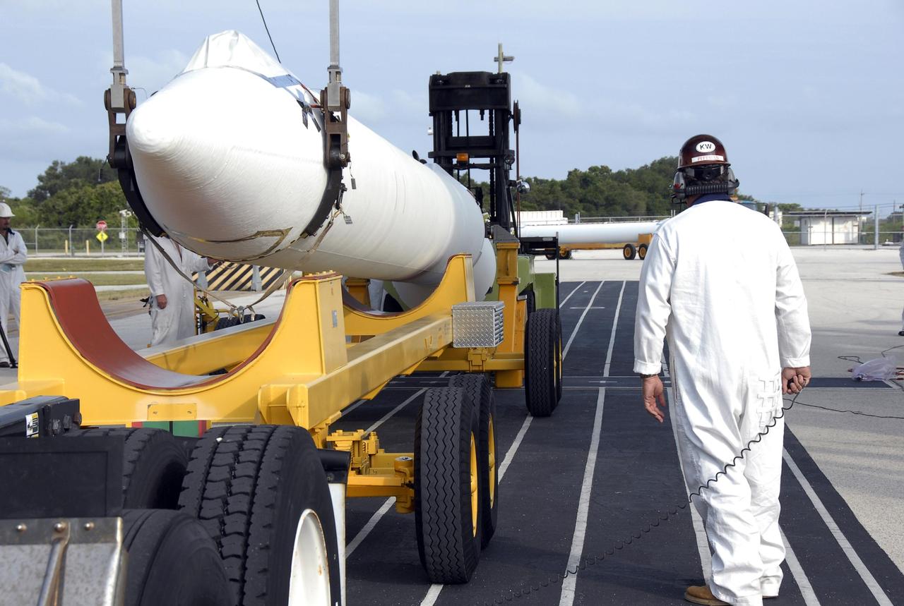 KENNEDY SPACE CENTER, FLA. -- On Pad 17-A at Cape Canaveral Air Force Station, the solid rocket booster is raised off its transporter. The SRB will be lifted into the mobile service tower for mating with the Delta II first stage. The Delta is the launch vehicle for the Phoenix Mars Lander spacecraft. Phoenix will land in icy soils near the north polar permanent ice cap of Mars and explore the history of the water in these soils and any associated rocks, while monitoring polar climate. Landing on Mars is planned in May 2008 on arctic ground where a mission currently in orbit, Mars Odyssey, has detected high concentrations of ice just beneath the top layer of soil. Phoenix is scheduled to launch Aug. 3. Photo credit: NASA/Kim Shiflett