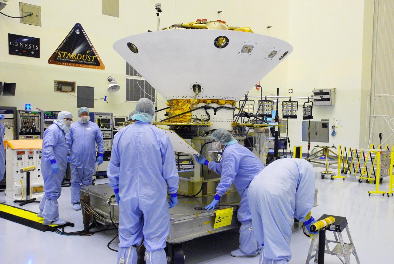 KENNEDY SPACE CENTER, FLA. --  In the Payload Hazardous Servicing Facility at Cape Canaveral Air Force Station, workers prepare the Phoenix Mars Lander spacecraft for solar panel deployment. The deployment of the panels is part of the pre-launch testing under way. Phoenix will land in icy soils near the north polar permanent ice cap of Mars and explore the history of the water in these soils and any associated rocks, while monitoring polar climate. Landing on Mars is planned in May 2008 on arctic ground where a mission currently in orbit, Mars Odyssey, has detected high concentrations of ice just beneath the top layer of soil.  Phoenix is scheduled to launch Aug. 3.  Photo credit: NASA/George Shelton