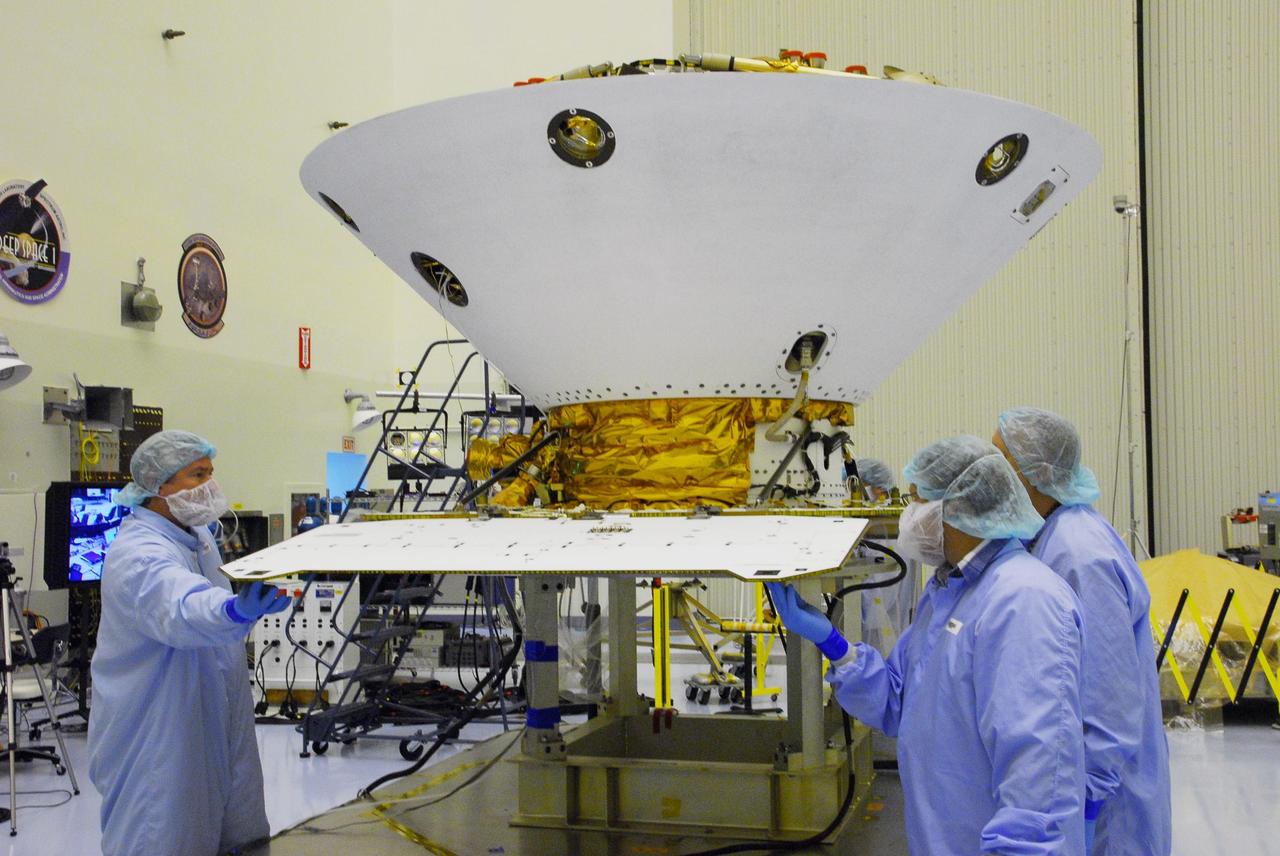 KENNEDY SPACE CENTER, FLA. -- In the Payload Hazardous Servicing Facility at Cape Canaveral Air Force Station, workers begin unfolding the solar array panels on the Phoenix Mars Lander spacecraft. The deployment of the panels is part of the pre-launch testing under way. Phoenix will land in icy soils near the north polar permanent ice cap of Mars and explore the history of the water in these soils and any associated rocks, while monitoring polar climate. Landing on Mars is planned in May 2008 on arctic ground where a mission currently in orbit, Mars Odyssey, has detected high concentrations of ice just beneath the top layer of soil. Phoenix is scheduled to launch Aug. 3. Photo credit: NASA/George Shelton