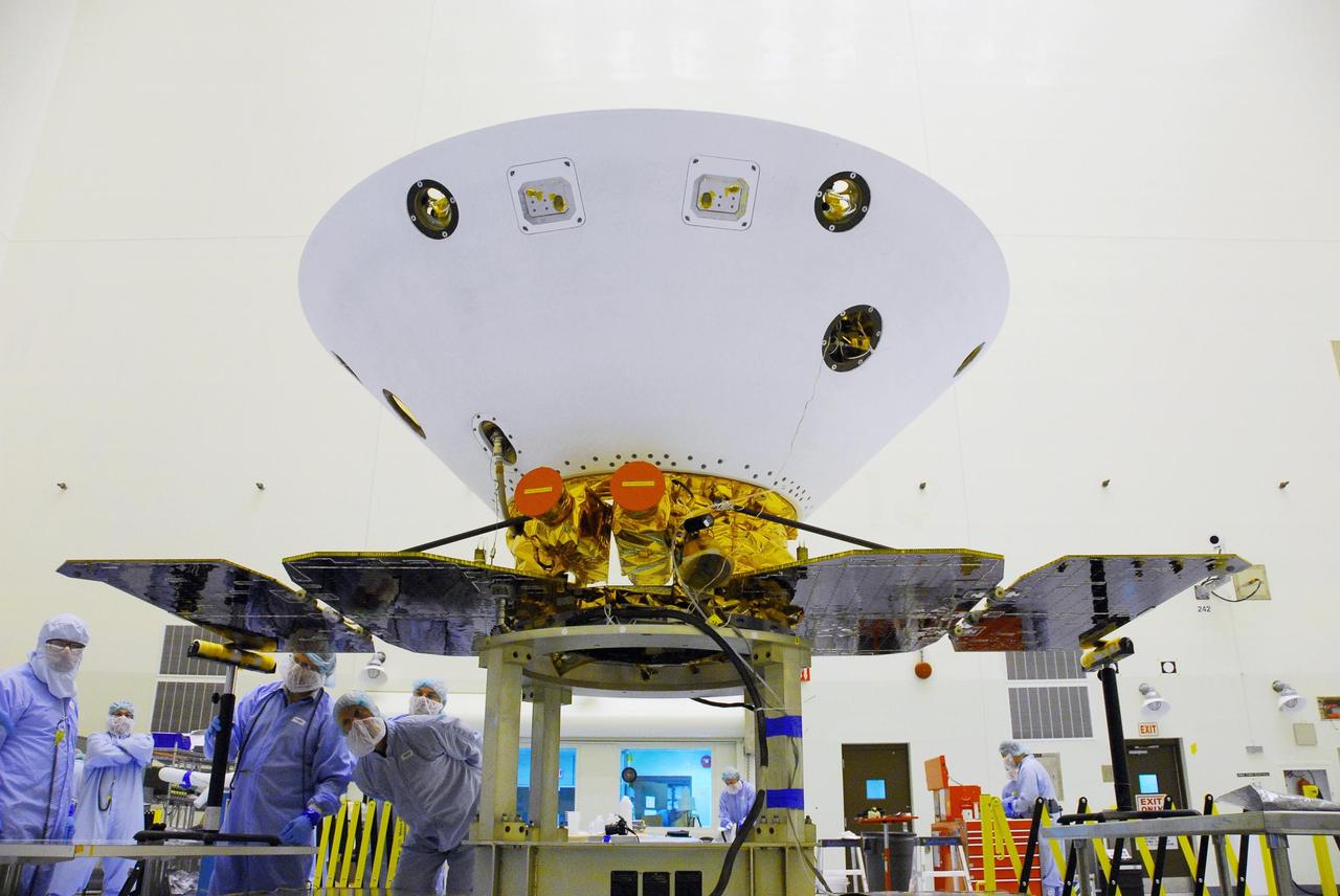 KENNEDY SPACE CENTER, FLA. -- In the Payload Hazardous Servicing Facility at Cape Canaveral Air Force Station, the solar array panels on the Phoenix Mars Lander spacecraft are unfolded. The deployment of the panels is part of the pre-launch testing under way. Phoenix will land in icy soils near the north polar permanent ice cap of Mars and explore the history of the water in these soils and any associated rocks, while monitoring polar climate. Landing on Mars is planned in May 2008 on arctic ground where a mission currently in orbit, Mars Odyssey, has detected high concentrations of ice just beneath the top layer of soil. Phoenix is scheduled to launch Aug. 3. Photo credit: NASA/George Shelton