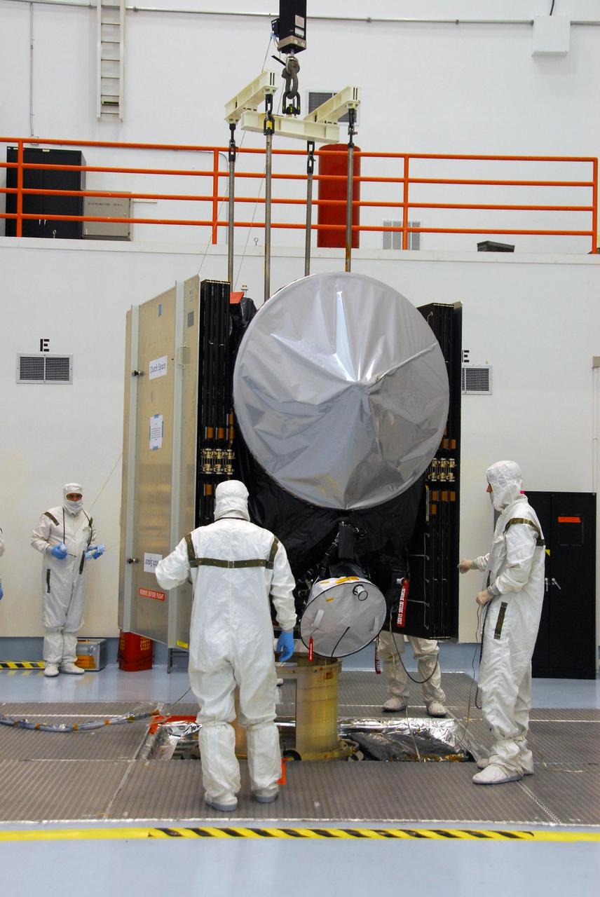 KENNEDY SPACE CENTER, FLA. -- At Astrotech, an overhead crane lifts the Dawn spacecraft from its stand to move and mate it to the upper stage booster for launch.  Dawn is scheduled to launch July 7 from Pad 17-B on Cape Canaveral Air Force Station.  Dawn's goal is to characterize the conditions and processes of the solar system's earliest epoch by investigating in detail the largest protoplanets that have remained intact since their formations: asteroid Vesta and the dwarf planet Ceres.  They reside in the extensive zone between Mars and Jupiter together with many other smaller bodies, called the asteroid belt.   Photo credit: NASA/George Shelton