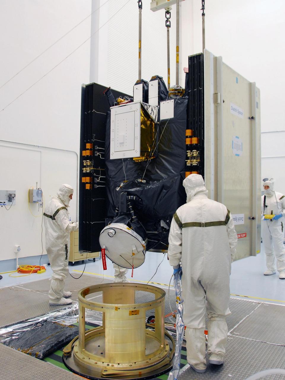 KENNEDY SPACE CENTER, FLA. -- At Astrotech, an overhead crane lifts the Dawn spacecraft from its stand to move it and mate it to the upper stage booster for launch.  Dawn is scheduled to launch July 7 from Pad 17-B on Cape Canaveral Air Force Station.  Dawn's goal is to characterize the conditions and processes of the solar system's earliest epoch by investigating in detail the largest protoplanets that have remained intact since their formations: asteroid Vesta and the dwarf planet Ceres.  They reside in the extensive zone between Mars and Jupiter together with many other smaller bodies, called the asteroid belt.   Photo credit: NASA/George Shelton