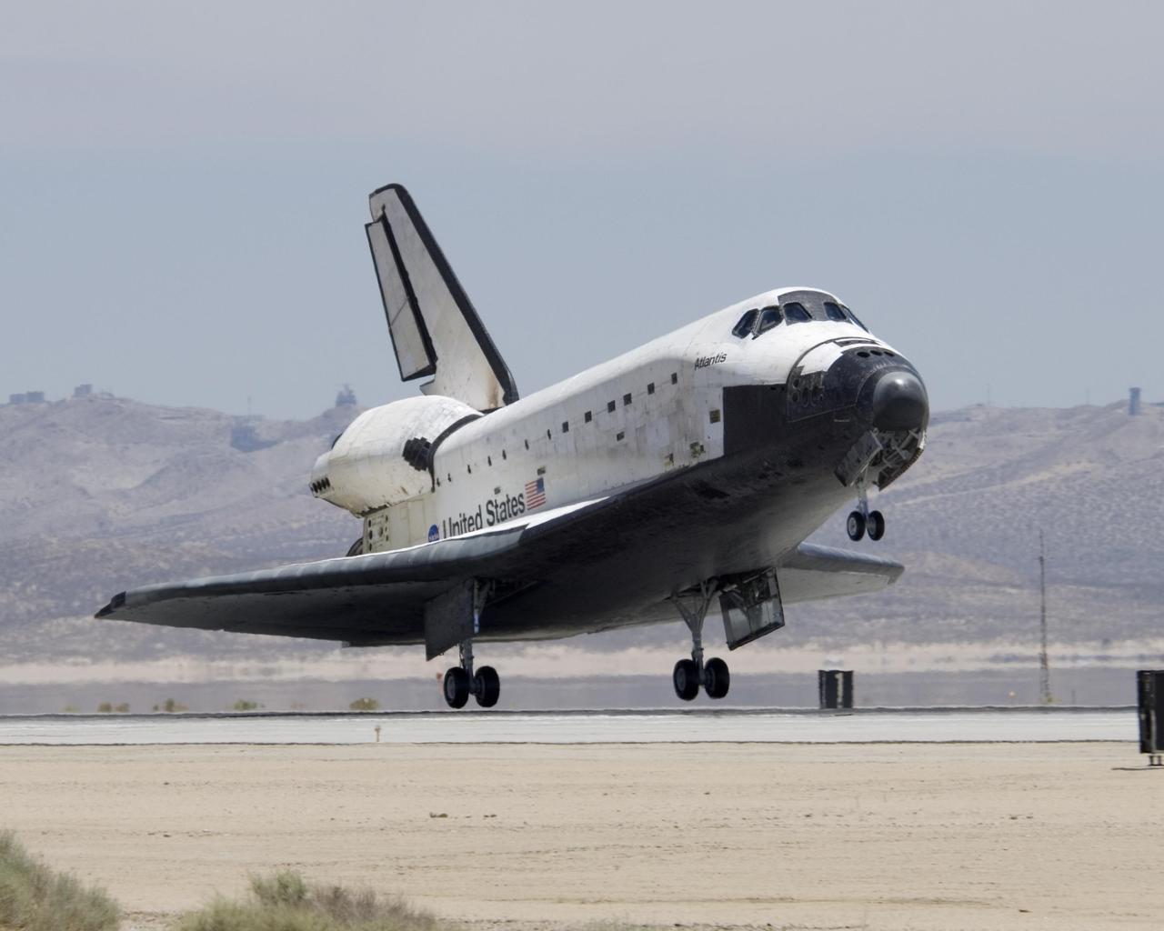 EDWARDS AIR FORCE BASE, CALIF. --  Returning from mission STS-117, Atlantis approaches touchdown on the runway at NASA's Dryden Flight Research Center at Edwards Air Force Base in California. Atlantis landed on orbit 219 after 13 days, 20 hours and 12 minutes in space.  The landing was diverted to California due to marginal weather at the Kennedy Space Center.  Main gear touchdown was at 3:49:38 p.m. EDT on runway 22.  Nose gear touchdown was at 3:49:49 p.m. and wheel stop was at 3:50:48 p.m.  This was the 51st landing for the Space Shuttle Program at Edwards Air Force Base. The mission to the International Space Station was a success, installing and activating the S3/S4 truss and retracting the P6 arrays.  The returning crew of seven includes astronaut Sunita Williams, who was flight engineer on the Expedition 15 crew.  She achieved a new milestone, a record-setting flight at 194 days, 18 hours and 58 minutes, the longest single spaceflight ever by a female astronaut or cosmonaut.   Photo credit: NASA/Tony Landis