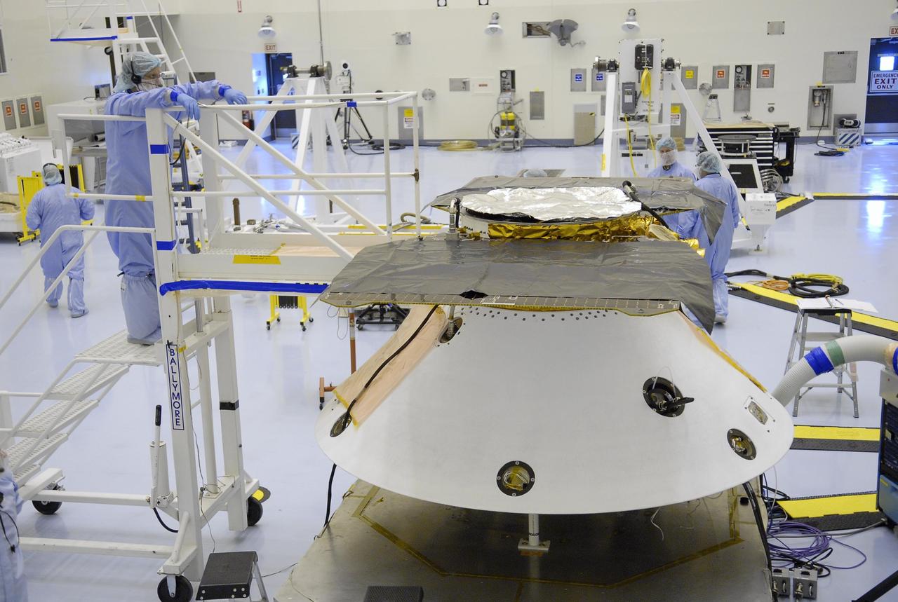 KENNEDY SPACE CENTER, FLA. -- In the Payload Hazardous Servicing Facility, the Phoenix Mars Lander spacecraft is prepared for illumination testing of its solar array panels. The Phoenix will be launched toward Mars to land in icy soils near the north polar permanent ice cap of Mars. It will explore the history of the water in these soils and any associated rocks, while monitoring polar climate. Landing on Mars is planned in May 2008 on arctic ground where a mission currently in orbit, Mars Odyssey, has detected high concentrations of ice just beneath the top layer of soil. Phoenix is scheduled to launch Aug. 3 from Pad 17-A at Cape Canaveral Air Force Station . Photo credit: NASA/Kim Shiflett