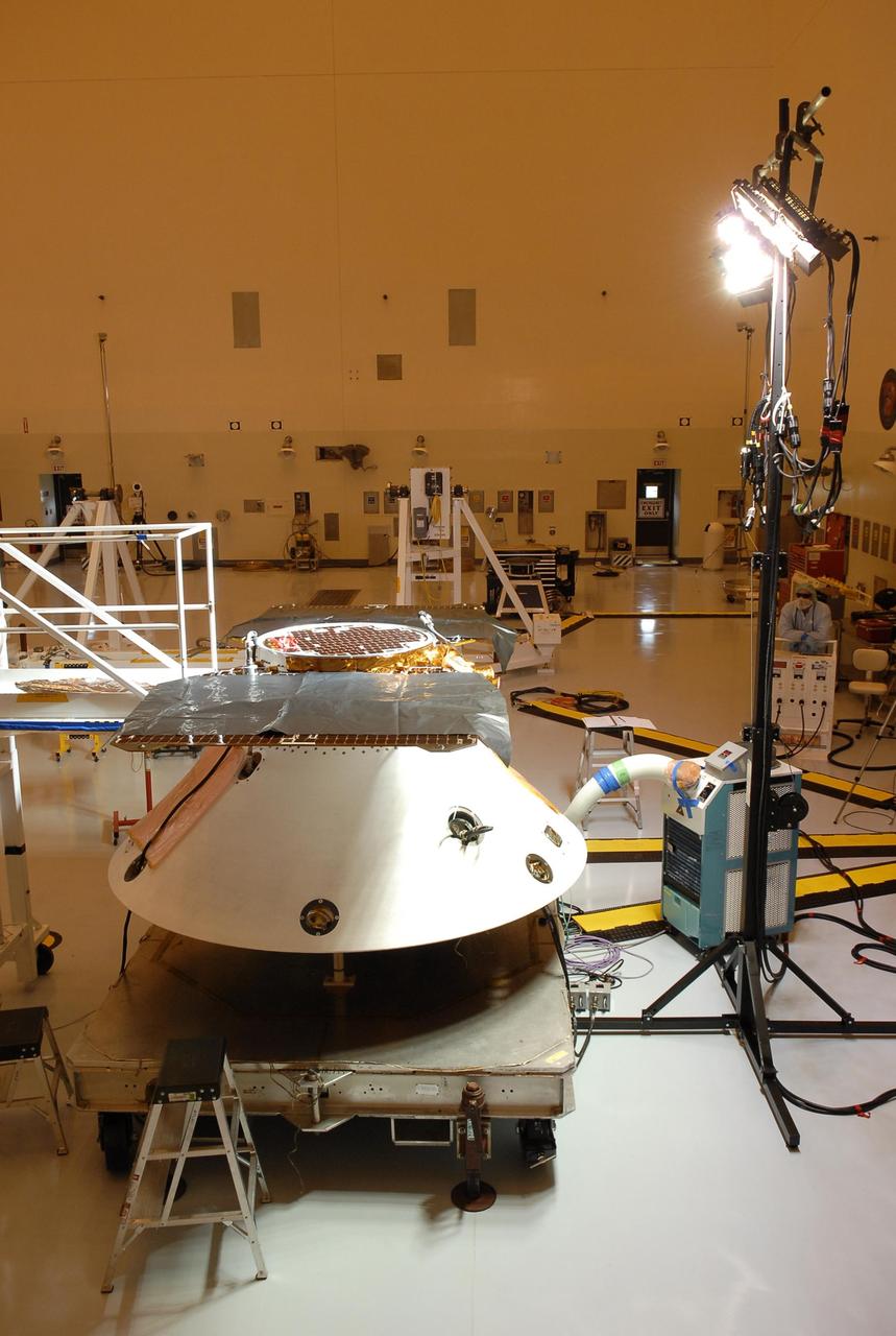 KENNEDY SPACE CENTER, FLA. -- In the Payload Hazardous Servicing Facility, the Phoenix Mars Lander spacecraft undergoes illumination testing of its solar array panels. The Phoenix will be launched toward Mars to land in icy soils near the planet's north polar permanent ice cap. It will explore the history of the water in these soils and any associated rocks, while monitoring polar climate. Landing on Mars is planned in May 2008 on arctic ground where a mission currently in orbit, Mars Odyssey, has detected high concentrations of ice just beneath the top layer of soil. Phoenix is scheduled to launch Aug. 3 from Pad 17-A at Cape Canaveral Air Force Station . Photo credit: NASA/Kim Shiflett