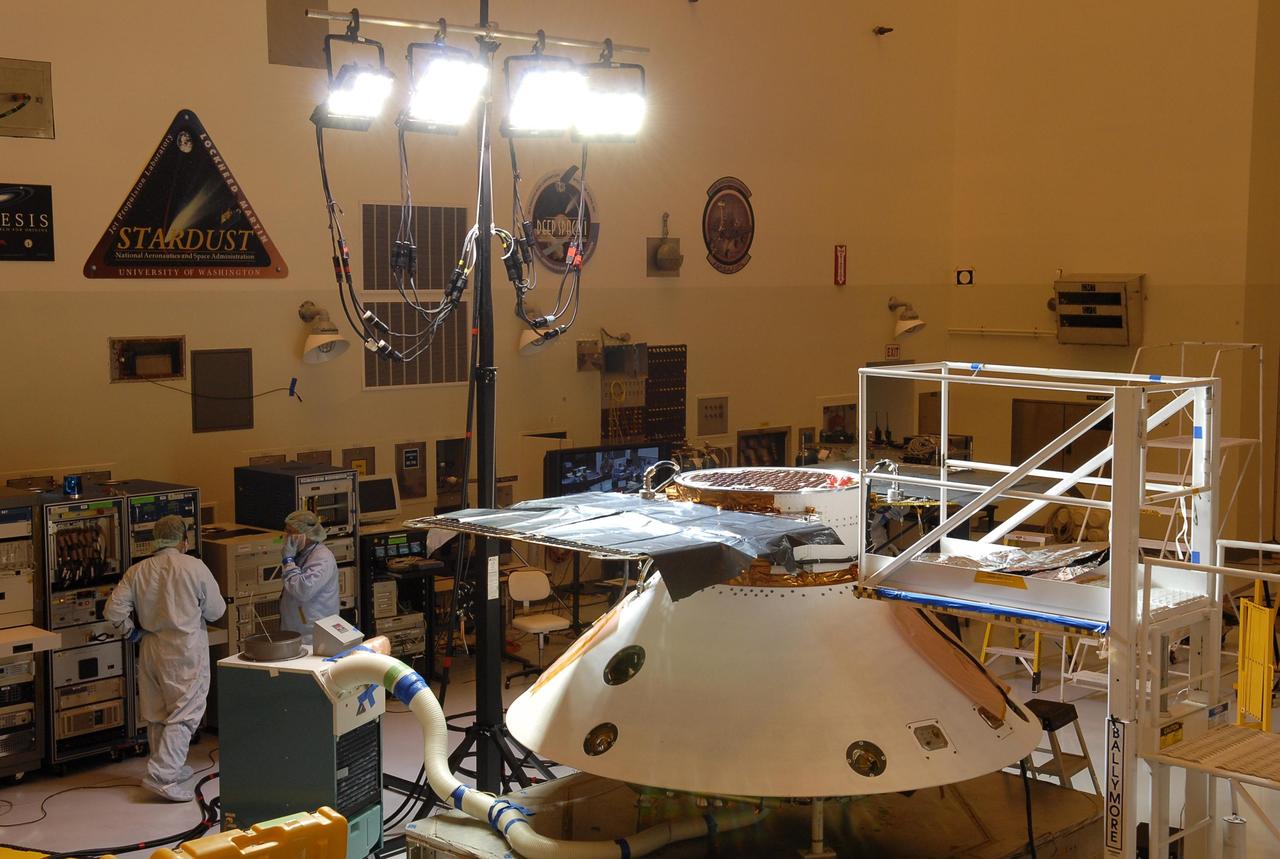 KENNEDY SPACE CENTER, FLA. -- In the Payload Hazardous Servicing Facility, the Phoenix Mars Lander spacecraft undergoes illumination testing of its solar array panels. The Phoenix will be launched toward Mars to land in icy soils near the planet's north polar permanent ice cap. It will explore the history of the water in these soils and any associated rocks, while monitoring polar climate. Landing on Mars is planned in May 2008 on arctic ground where a mission currently in orbit, Mars Odyssey, has detected high concentrations of ice just beneath the top layer of soil. Phoenix is scheduled to launch Aug. 3 from Pad 17-A at Cape Canaveral Air Force Station . Photo credit: NASA/Kim Shiflett