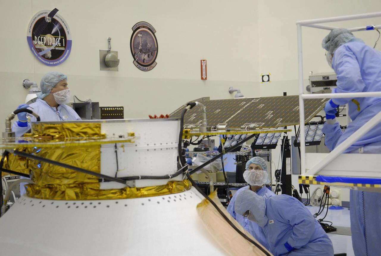 KENNEDY SPACE CENTER, FLA. -- After illumination testing of the solar array panels, technicians begin stowing the panels on the Phoenix Mars Lander spacecraft. The Phoenix will be launched toward Mars to land in icy soils near the planet's north polar permanent ice cap. It will explore the history of the water in these soils and any associated rocks, while monitoring polar climate. Landing on Mars is planned in May 2008 on arctic ground where a mission currently in orbit, Mars Odyssey, has detected high concentrations of ice just beneath the top layer of soil. Phoenix is scheduled to launch Aug. 3 from Pad 17-A at Cape Canaveral Air Force Station . Photo credit: NASA/Kim Shiflett
