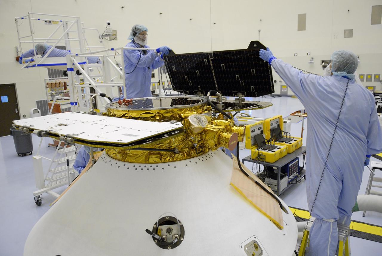 KENNEDY SPACE CENTER, FLA. -- After illumination testing of the solar array panels, technicians begin stowing the panels on the Phoenix Mars Lander spacecraft. The Phoenix will be launched toward Mars to land in icy soils near the planet's north polar permanent ice cap. It will explore the history of the water in these soils and any associated rocks, while monitoring polar climate. Landing on Mars is planned in May 2008 on arctic ground where a mission currently in orbit, Mars Odyssey, has detected high concentrations of ice just beneath the top layer of soil. Phoenix is scheduled to launch Aug. 3 from Pad 17-A at Cape Canaveral Air Force Station . Photo credit: NASA/Kim Shiflett