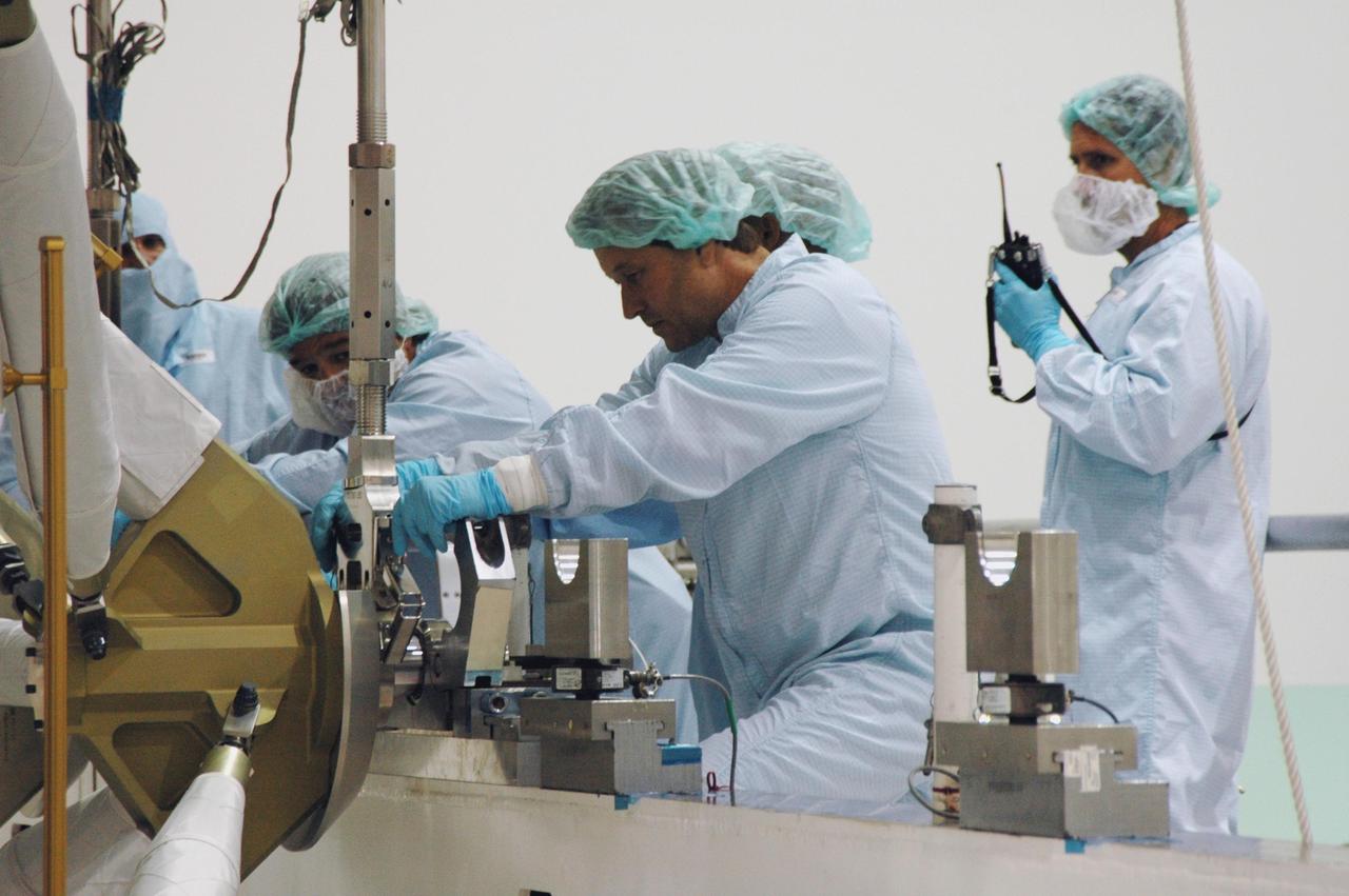 KENNEDY SPACE CENTER, FLA. -- In the Space Station Processing Facility, workers attach a crane to the S5 integrated truss to move it to the payload canister. It will join the external stowage platform 3 (ESP3) already in the canister. Endeavour is targeted for launch on Aug. 9 to the International Space Station. The mission will continue space station construction by delivering the third starboard truss segment, as well as carrying the ESP3 and the SPACEHAB module. Photo credit: NASA/Dimitri Gerondidakis