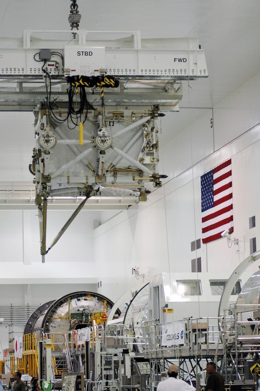 KENNEDY SPACE CENTER, FLA. -- In the Space Station Processing Facility, the overhead crane moves the S5 integrated truss across other modules toward the payload canister. It will join the external stowage platform 3 (ESP3) already in the canister. Endeavour is targeted for launch on Aug. 9 to the International Space Station. The mission will continue space station construction by delivering the third starboard truss segment, as well as carrying the ESP3 and the SPACEHAB module. Photo credit: NASA/Dimitri Gerondidakis