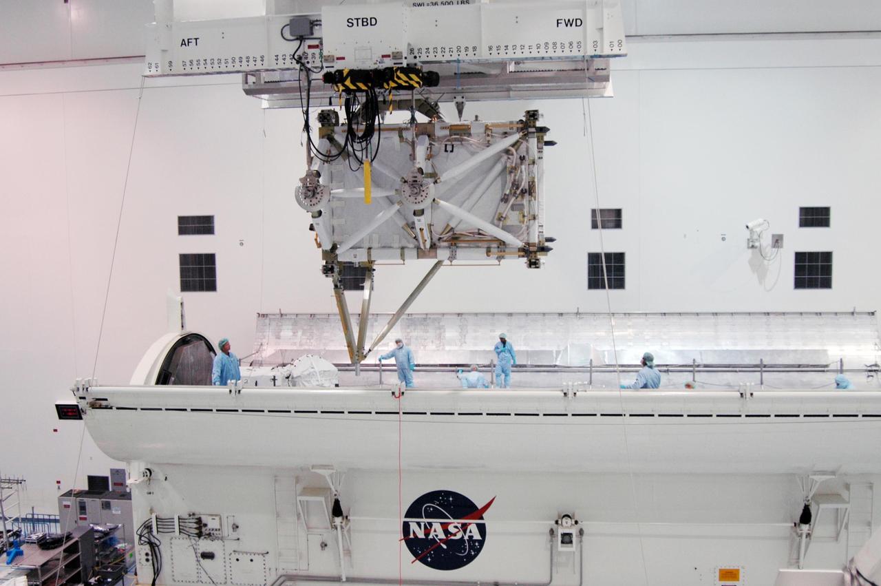 KENNEDY SPACE CENTER, FLA. -- In the Space Station Processing Facility, the overhead crane moves the S5 integrated truss over the payload canister, where it will be stowed. The S5 joins the external stowage platform 3 (ESP3) already in the canister. Endeavour is targeted for launch on Aug. 9 to the International Space Station. The mission will continue space station construction by delivering the third starboard truss segment, as well as carrying the ESP3 and the SPACEHAB module. Photo credit: NASA/Dimitri Gerondidakis