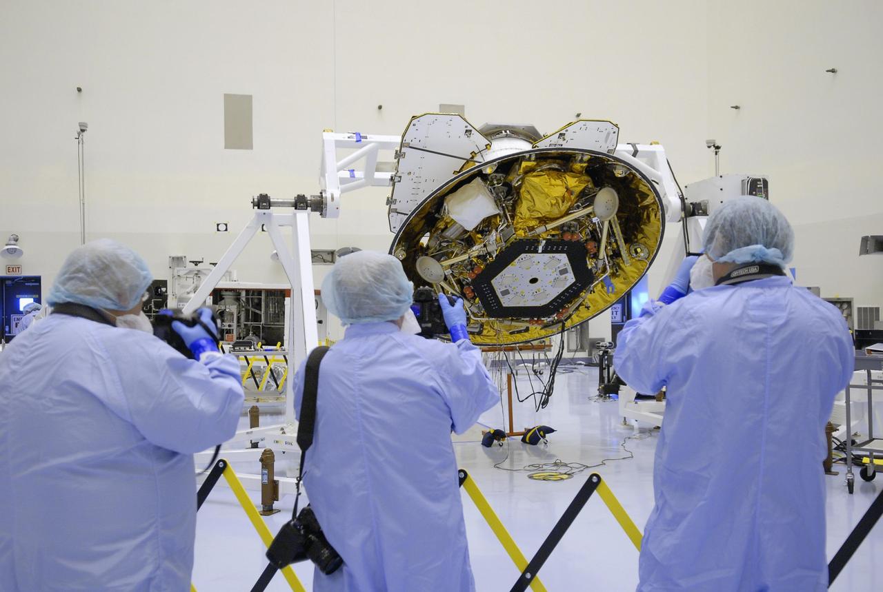 KENNEDY SPACE CENTER, FLA. -- In the Payload Hazardous Servicing Facility, photographers dressed in clean-room suits, are able to get closeup shots of the Phoenix Mars Lander. Phoenix is scheduled to launch Aug. 3 from Launch Pad 17-A at Cape Canaveral Air Force Station. Phoenix will land in icy soils near the north polar permanent ice cap of Mars and explore the history of the water in these soils and any associated rocks, while monitoring polar climate. Landing on Mars is planned in May 2008 on arctic ground where a mission currently in orbit, Mars Odyssey, has detected high concentrations of ice just beneath the top layer of soil. Photo credit: NASA/Kim Shiflett