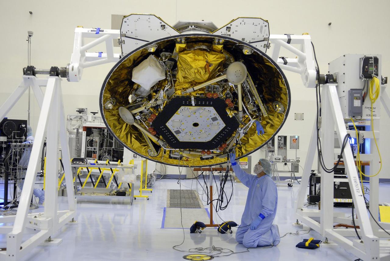 KENNEDY SPACE CENTER, FLA. -- In the Payload Hazardous Servicing Facility, a technician takes a measurement on the Phoenix Mars Lander. The spacecraft is on display for the media. Phoenix is scheduled to launch Aug. 3 from Launch Pad 17-A at Cape Canaveral Air Force Station. Phoenix will land in icy soils near the north polar permanent ice cap of Mars and explore the history of the water in these soils and any associated rocks, while monitoring polar climate. Landing on Mars is planned in May 2008 on arctic ground where a mission currently in orbit, Mars Odyssey, has detected high concentrations of ice just beneath the top layer of soil. Photo credit: NASA/Kim Shiflett