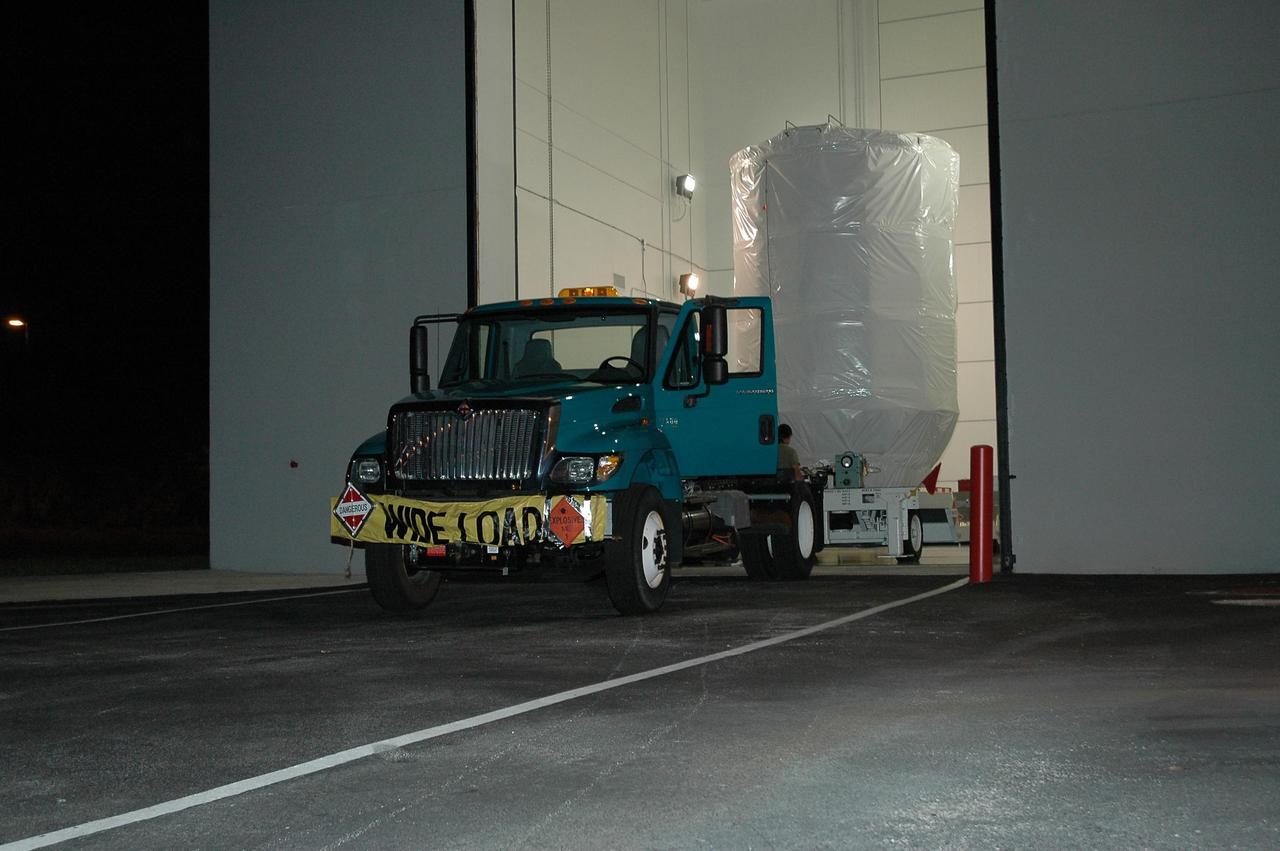 KENNEDY SPACE CENTER, FLA. -- NASA's Dawn spacecraft moves out of the Astrotech facility in Titusville, Fla., for transportation to Launch Pad 17-B at Cape Canaveral Air Force Station, and mate to the Delta II launch vehicle. Launch is scheduled for July 7. Dawn is the ninth mission in NASA's Discovery Program. The spacecraft will be the first to orbit two planetary bodies, asteroid Vesta and dwarf planet Ceres, during a single mission. Vesta and Ceres lie in the asteroid belt between Mars and Jupiter. It is also NASA's first purely scientific mission powered by three solar electric ion propulsion engines. Photo credit: NASA/Troy Cryder.