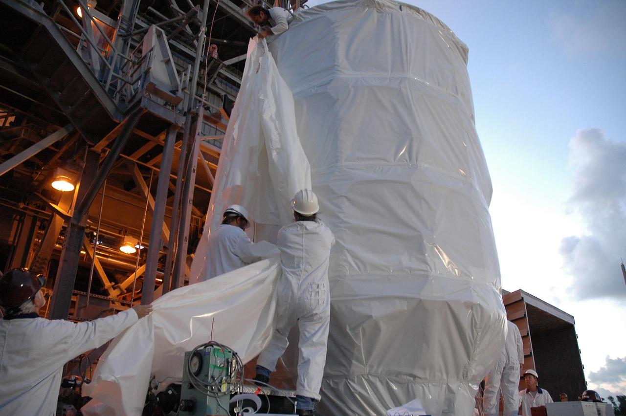 KENNEDY SPACE CENTER, FLA. --  At Launch Pad 17-B, at Cape Canaveral Air Force Station, workers attach a crane to NASA's Dawn spacecraft. It will be lifted into the mobile service tower for mating to the Delta II launch vehicle.Launch is scheduled for July 7. Dawn is the ninth mission in NASA's Discovery Program. The spacecraft will be the first to orbit two planetary bodies, asteroid Vesta and dwarf planet Ceres,  during a single mission. Vesta and Ceres lie in the asteroid belt between Mars and Jupiter. It is also NASA's first purely scientific mission powered by three solar electric ion propulsion engines. Photo credit: NASA/Troy Cryder.