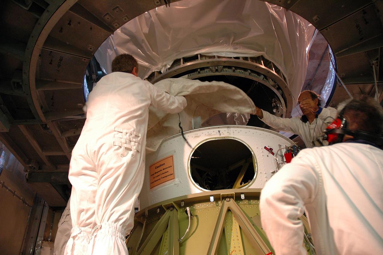 KENNEDY SPACE CENTER, FLA. -- At Launch Pad 17-B, at Cape Canaveral Air Force Station, workers position NASA’s Dawn spacecraft to lower it toward the Delta II launch vehicle. Launch is scheduled for July 7. Dawn is the ninth mission in NASA's Discovery Program. The spacecraft will be the first to orbit two planetary bodies, asteroid Vesta and dwarf planet Ceres, during a single mission. Vesta and Ceres lie in the asteroid belt between Mars and Jupiter. It is also NASA’s first purely scientific mission powered by three solar electric ion propulsion engines. Photo credit: NASA/Troy Cryder.