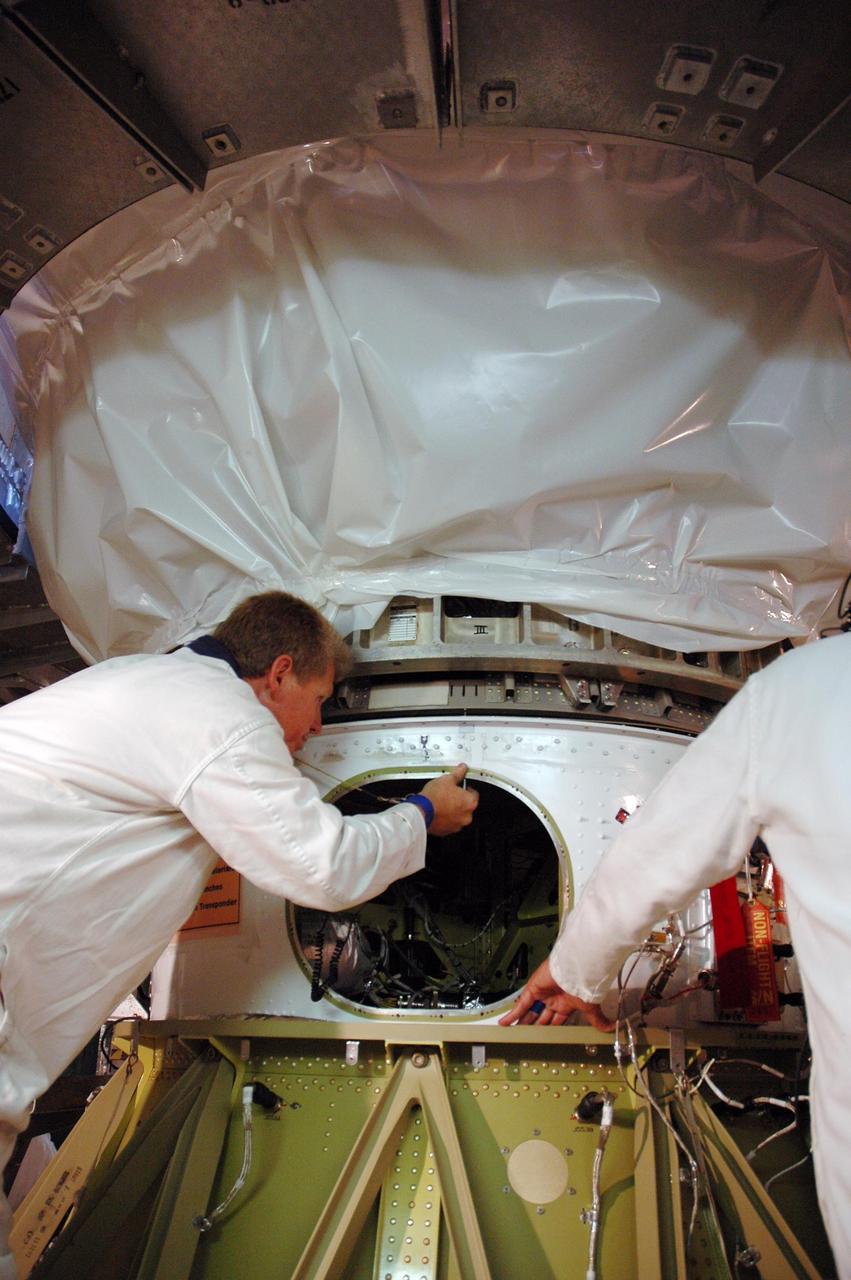 KENNEDY SPACE CENTER, FLA. -- At Launch Pad 17-B, at Cape Canaveral Air Force Station, workers position NASA's Dawn spacecraft to mate it with the Delta II launch vehicle below. Launch is scheduled for July 7. Dawn is the ninth mission in NASA’s Discovery Program. The spacecraft will be the first to orbit two planetary bodies, asteroid Vesta and dwarf planet Ceres, during a single mission. Vesta and Ceres lie in the asteroid belt between Mars and Jupiter. It is also NASA’s first purely scientific mission powered by three solar electric ion propulsion engines. Photo credit: NASA/Troy Cryder.