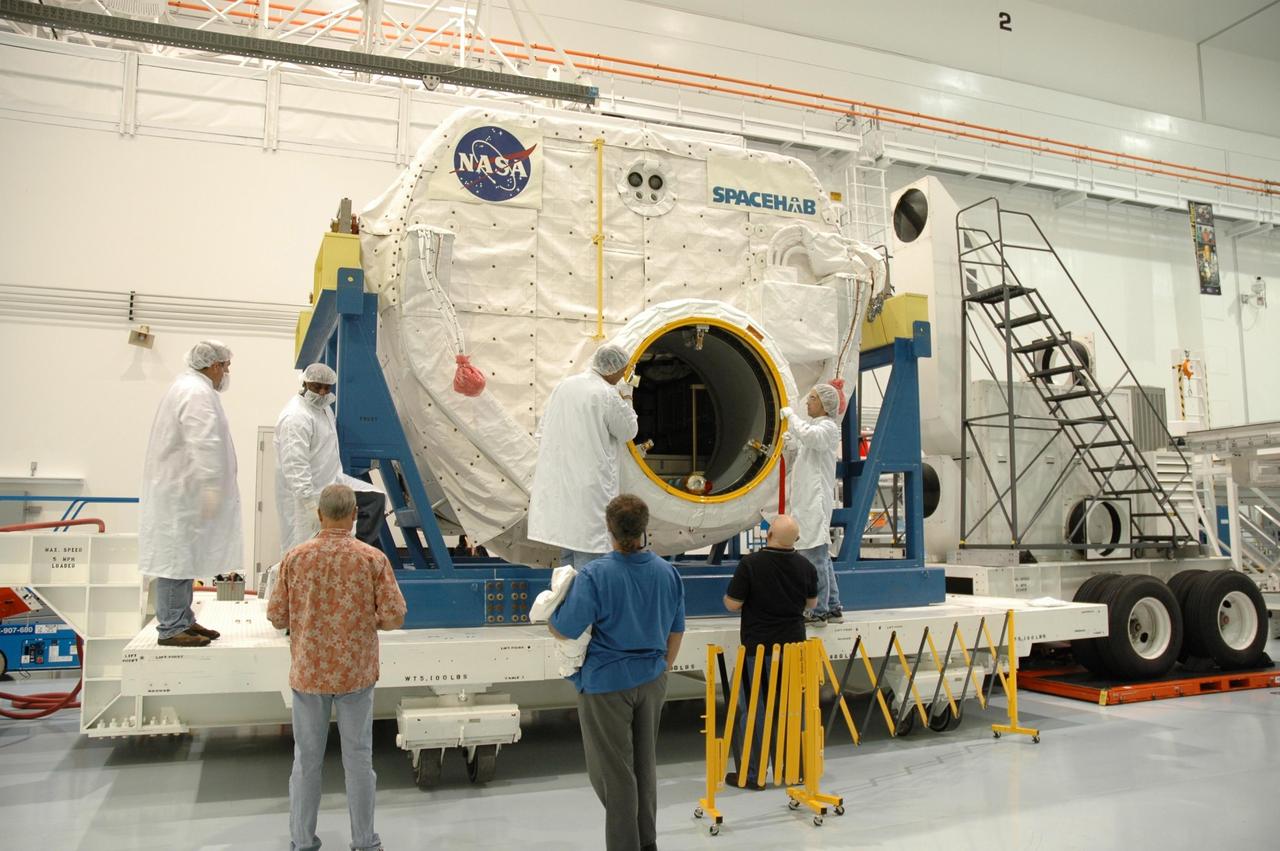KENNEDY SPACE CENTER, FLA. -- In the Space Station Processing Facility, workers prepare the Spacehab module for its move to the payload canister. The module is part of the payload on mission STS-118 and will be loaded into Space Shuttle Endeavour's payload bay at the pad. Endeavour is targeted for launch on Aug. 9 to the International Space Station. The mission will continue space station construction by delivering a third starboard truss segment, S5, as well as carrying the external stowage platform 3 and Spacehab module. Photo credit: NASA/Jim Grossmann