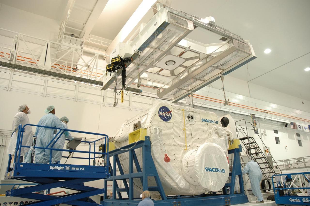 KENNEDY SPACE CENTER, FLA. -- In the Space Station Processing Facility, an overhead crane is moved into place above the Spacehab module to move it to the payload canister. The module is part of the payload on mission STS-118 and will be loaded into Space Shuttle Endeavour's payload bay at the pad. Endeavour is targeted for launch on Aug. 9 to the International Space Station. The mission will continue space station construction by delivering a third starboard truss segment, S5, as well as carrying the external stowage platform 3 and Spacehab module. Photo credit: NASA/Jim Grossmann