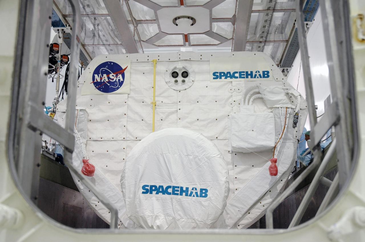 KENNEDY SPACE CENTER, FLA. -- In the Space Station Processing Facility, the Spacehab module is settled into place in the payload canister. The module is part of the payload on mission STS-118 and will be loaded into Space Shuttle Endeavour's payload bay at the pad. Endeavour is targeted for launch on Aug. 9 to the International Space Station. The mission will continue space station construction by delivering a third starboard truss segment, S5, as well as carrying the external stowage platform 3 and Spacehab module. Photo credit: NASA/Jim Grossmann