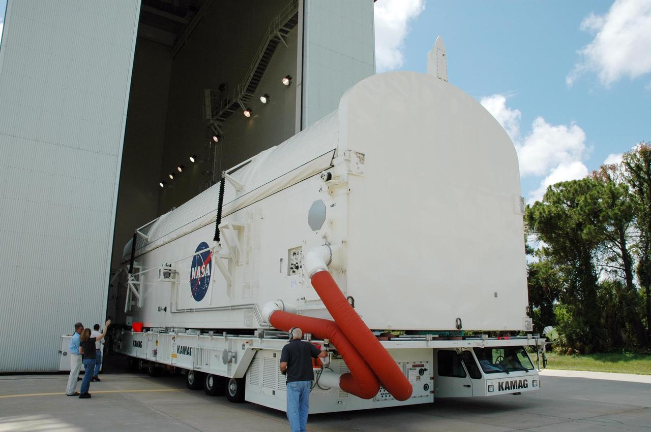KENNEDY SPACE CENTER, FLA. --  The STS-118 payload canister transporter moves into the Canister Rotation Facility.  Inside the canister are the SPACEHAB module, the S5 truss and the external stowage platform 3.  At the CRF, the canister will be raised to a vertical position for delivery to Launch Pad 39A.  Endeavour is targeted for launch on Aug. 9 to the International Space Station. The mission will continue space station construction with installation of the truss.  Photo credit: NASA/Jim Grossmann