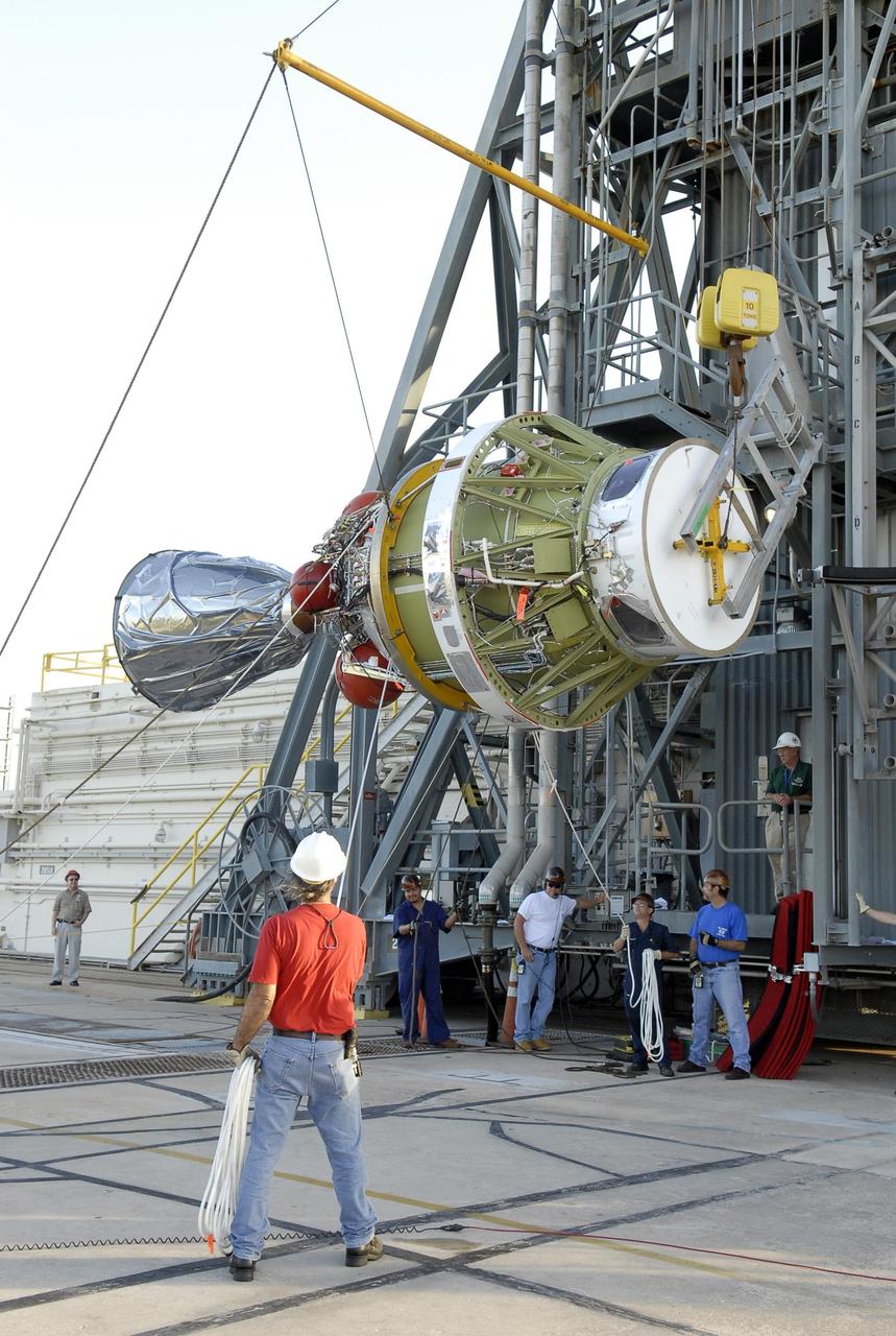 KENNEDY SPACE CENTER, FLA. -- On Launch Pad 17-A at Cape Canaveral Air Force Station, a crane lifts the second stage of the Delta II launch vehicle for NASA's Phoenix Mars Lander to go into the mobile service tower. The second stage will be lifted into the mobile service tower and mated with the Delta's first stage. Phoenix is scheduled to launch Aug. 3. Phoenix will land in icy soils near the north polar permanent ice cap of Mars and explore the history of the water in these soils and any associated rocks, while monitoring polar climate. Landing on Mars is planned in May 2008 on arctic ground where a mission currently in orbit, Mars Odyssey, has detected high concentrations of ice just beneath the top layer of soil. Photo credit: NASA/Kim Shiflett