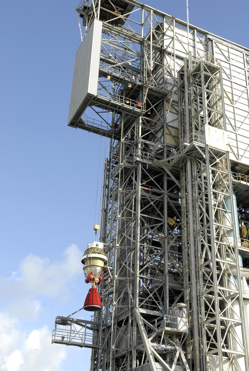 KENNEDY SPACE CENTER, FLA. -- The second stage of the Delta II launch vehicle for NASA's Phoenix Mars Lander is lifted up the mobile service tower on Launch Pad 17-A at Cape Canaveral Air Force Station. It will be moved into the tower and lowered for mating with the Delta's first stage. Phoenix is scheduled to launch Aug. 3. Phoenix will land in icy soils near the north polar permanent ice cap of Mars and explore the history of the water in these soils and any associated rocks, while monitoring polar climate. Landing on Mars is planned in May 2008 on arctic ground where a mission currently in orbit, Mars Odyssey, has detected high concentrations of ice just beneath the top layer of soil. Photo credit: NASA/Kim Shiflett