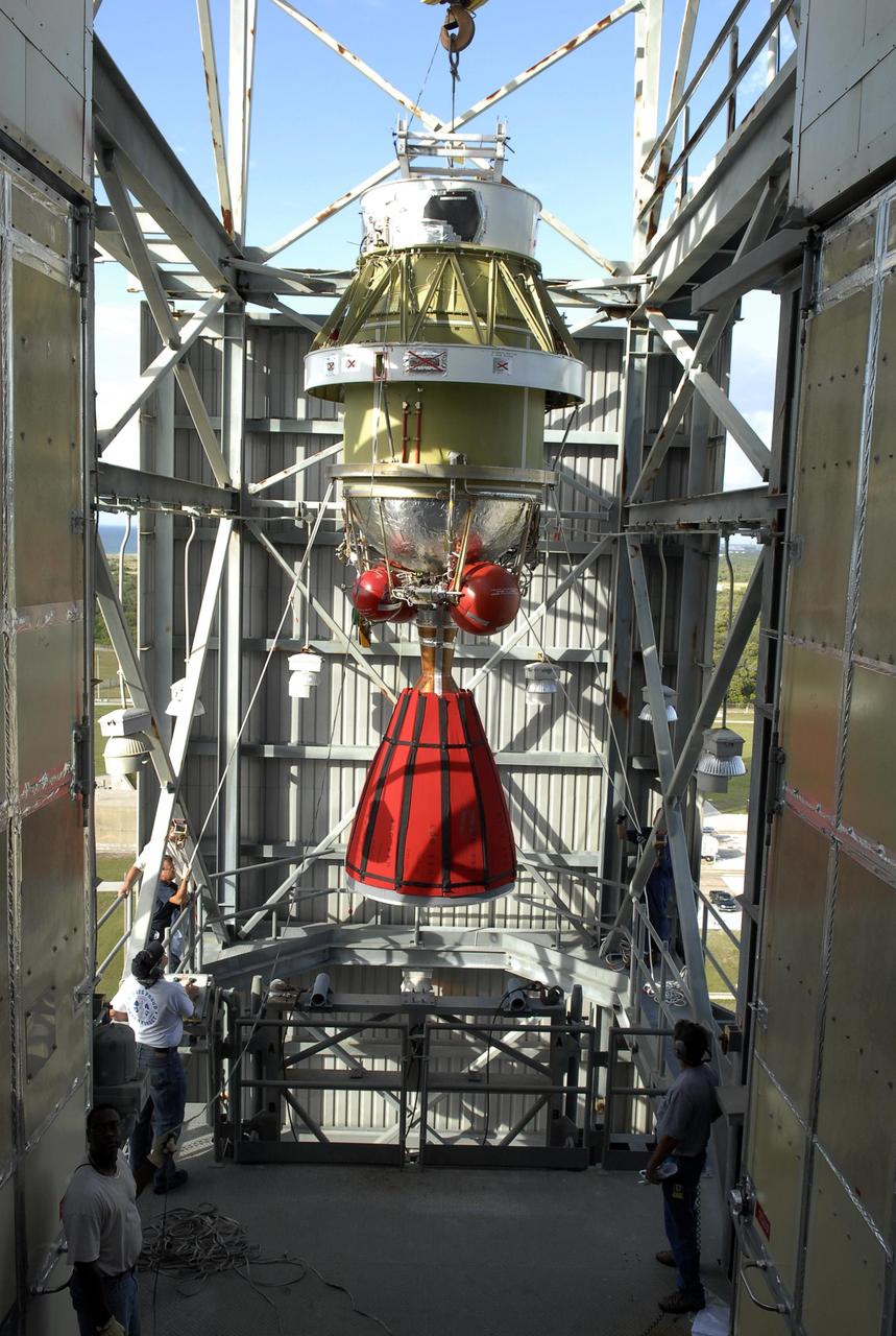 KENNEDY SPACE CENTER, FLA. -- On Launch Pad 17-A at Cape Canaveral Air Force Station, the second stage of the Delta II launch vehicle for NASA's Phoenix Mars Lander is moved into the mobile service tower. It will be lowered onto the Delta's first stage below for mating. Phoenix is scheduled to launch Aug. 3. Phoenix will land in icy soils near the north polar permanent ice cap of Mars and explore the history of the water in these soils and any associated rocks, while monitoring polar climate. Landing on Mars is planned in May 2008 on arctic ground where a mission currently in orbit, Mars Odyssey, has detected high concentrations of ice just beneath the top layer of soil. Photo credit: NASA/Kim Shiflett