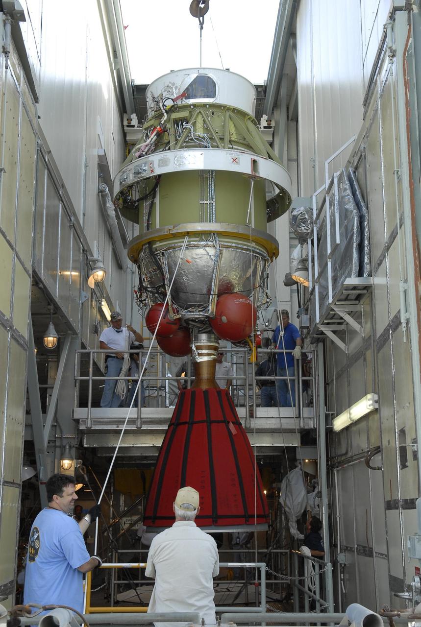 KENNEDY SPACE CENTER, FLA. -- On Launch Pad 17-A at Cape Canaveral Air Force Station, workers supervise the lowering of the second stage of the Delta II launch vehicle toward the Delta's first stage below. Phoenix is scheduled to launch Aug. 3. Phoenix will land in icy soils near the north polar permanent ice cap of Mars and explore the history of the water in these soils and any associated rocks, while monitoring polar climate. Landing on Mars is planned in May 2008 on arctic ground where a mission currently in orbit, Mars Odyssey, has detected high concentrations of ice just beneath the top layer of soil. Photo credit: NASA/Kim Shiflett