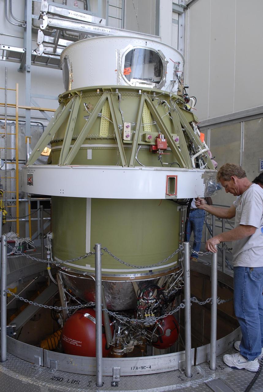 KENNEDY SPACE CENTER, FLA. -- On Launch Pad 17-A at Cape Canaveral Air Force Station, workers supervise the lowering of the second stage of the Delta II launch vehicle toward the Delta's first stage below. Phoenix is scheduled to launch Aug. 3. Phoenix will land in icy soils near the north polar permanent ice cap of Mars and explore the history of the water in these soils and any associated rocks, while monitoring polar climate. Landing on Mars is planned in May 2008 on arctic ground where a mission currently in orbit, Mars Odyssey, has detected high concentrations of ice just beneath the top layer of soil. Photo credit: NASA/Kim Shiflett
