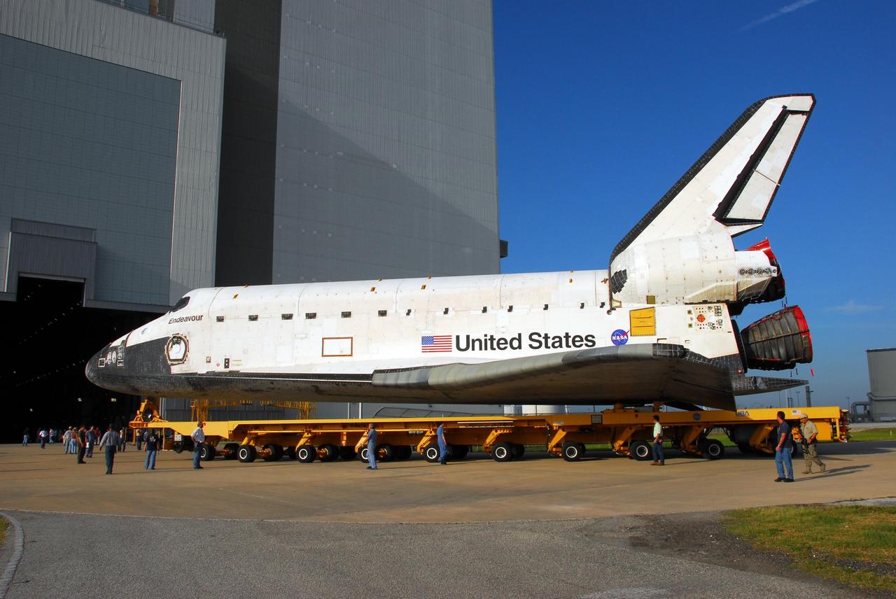 KENNEDY SPACE CENTER, FLA. -- The orbiter Endeavour, atop its transporter, rolls toward the gaping doorway of the Vehicle Assembly Building. In the VAB, it will be stacked with the external tank and solid rocket boosters atop the mobile launcher platform for its launch on mission STS-118. The mission will be Endeavour's first flight in more than four years. The shuttle has undergone extensive modifications, including the addition of safety upgrades already added to shuttles Discovery and Atlantis. Endeavour also features new hardware, such as the Station-to-Shuttle Power Transfer System that will allow the docked shuttle to draw electrical power from the station and extend its visits to the orbiting lab. Endeavour is targeted for launch on Aug. 7. Photo credit: NASA/George Shelton