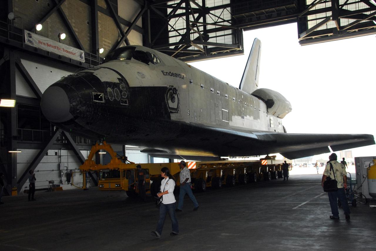 KENNEDY SPACE CENTER, FLA. -- The orbiter Endeavour, atop its transporter, is inside the Vehicle Assembly Building after rolling from the Orbiter Processing Facility bay 2. In the VAB, it will be stacked with the external tank and solid rocket boosters atop the mobile launcher platform for its launch on mission STS-118. The mission will be Endeavour's first flight in more than four years. The shuttle has undergone extensive modifications, including the addition of safety upgrades already added to shuttles Discovery and Atlantis. Endeavour also features new hardware, such as the Station-to-Shuttle Power Transfer System that will allow the docked shuttle to draw electrical power from the station and extend its visits to the orbiting lab. Endeavour is targeted for launch on Aug. 7. Photo credit: NASA/George Shelton