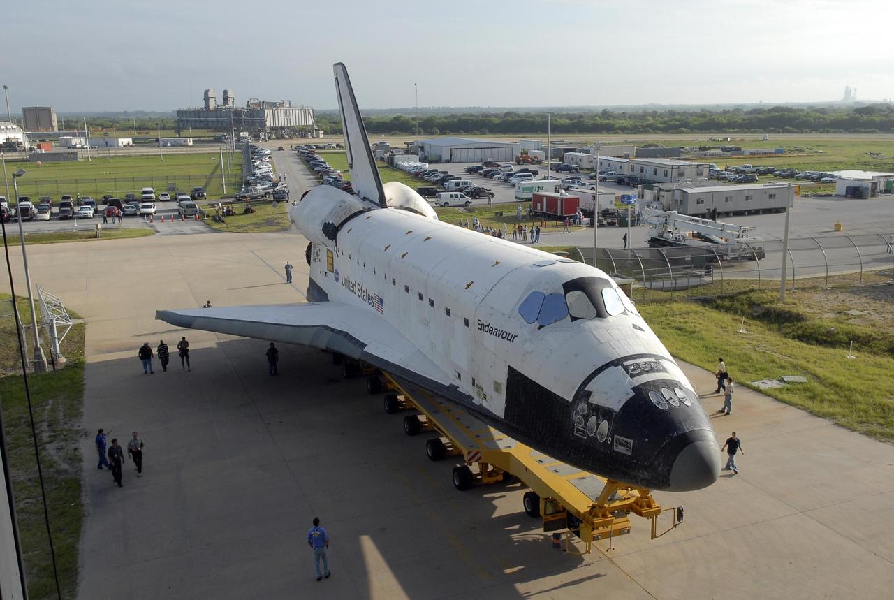 KENNEDY SPACE CENTER, FLA. -- After leaving the Orbiter Processing Facility bay 2, the orbiter Endeavour, atop its transporter, rolls toward the Vehicle Assembly Building. In the VAB, it will be stacked with the external tank and solid rocket boosters atop the mobile launcher platform for its launch on mission STS-118. The mission will be Endeavour's first flight in more than four years. The shuttle has undergone extensive modifications, including the addition of safety upgrades already added to shuttles Discovery and Atlantis. Endeavour also features new hardware, such as the Station-to-Shuttle Power Transfer System that will allow the docked shuttle to draw electrical power from the station and extend its visits to the orbiting lab. Endeavour is targeted for launch on Aug. 7. Photo credit: NASA/Kim Shiflett