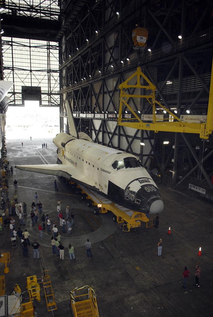 KENNEDY SPACE CENTER, FLA. -- The orbiter Endeavour, atop its transporter, rolls under the overhead crane in the transfer aisle of the Vehicle Assembly Building. In the VAB, the crane will lift the orbiter then lower it onto the mobile launcher platform where it will be stacked with the external tank and solid rocket boosters for launch on mission STS-118. The mission will be Endeavour's first flight in more than four years. The shuttle has undergone extensive modifications, including the addition of safety upgrades already added to shuttles Discovery and Atlantis. Endeavour also features new hardware, such as the Station-to-Shuttle Power Transfer System that will allow the docked shuttle to draw electrical power from the station and extend its visits to the orbiting lab. Endeavour is targeted for launch on Aug. 7. Photo credit: NASA/Kim Shiflett