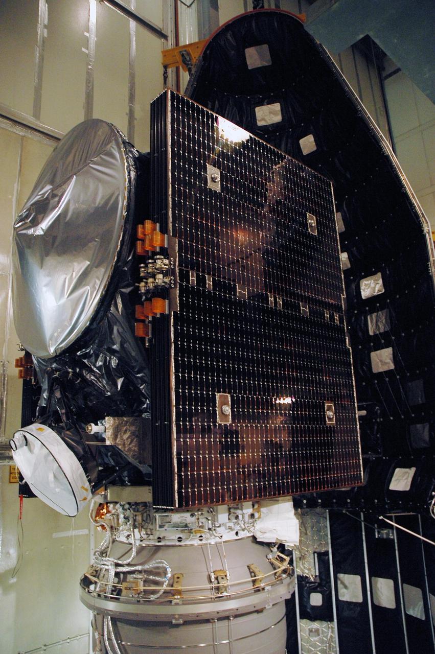 KENNEDY SPACE CENTER, FLA. --   On Launch Pad 17-B at Cape Canaveral Air Force Station in Florida, the first half of the fairing moves toward NASA's Dawn spacecraft for encapsulation. The fairing is a molded structure that fits flush with the outside surface of the Delta II upper stage booster and forms an aerodynamically smooth nose cone, protecting the spacecraft during launch and ascent. Dawn's goal is to characterize the conditions and processes of the solar system's earliest epoch 4.5 billion years ago by investigating in detail two of the largest asteroids, Ceres and Vesta. They reside between Mars and Jupiter in the asteroid belt.  Launch is scheduled for July 8.  Photo credit: NASA/Amanda Diller