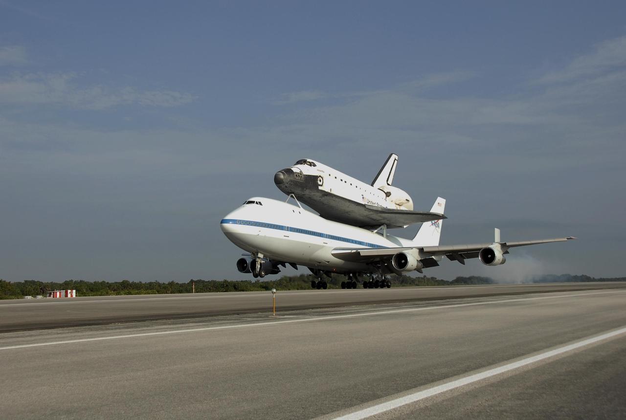 KENNEDY SPACE CENTER, FLA. -- The shuttle carrier aircraft, or SCA, and its piggyback passenger Atlantis kick up a little dust at touchdown on the KSC Shuttle Landing Facility. Touchdown was at 8:27 a.m. EDT. The SCA is a modified Boeing 747 jetliner. Atlantis landed at Edwards Air Force Base in California to end mission STS-117. The return to KSC began July 1 and took three days after stops across the country for fuel. The last stop was at Ft. Campbell in Kentucky. Weather conditions over the last leg postponed the return trip until July 3. Atlantis will be removed from the back of the SCA via the mate/demate device at the SLF. It will then be towed to the Orbiter Processing Facility to begin processing for its next launch, mission STS-122 in December. Photo credit: NASA/Kim Shiflett