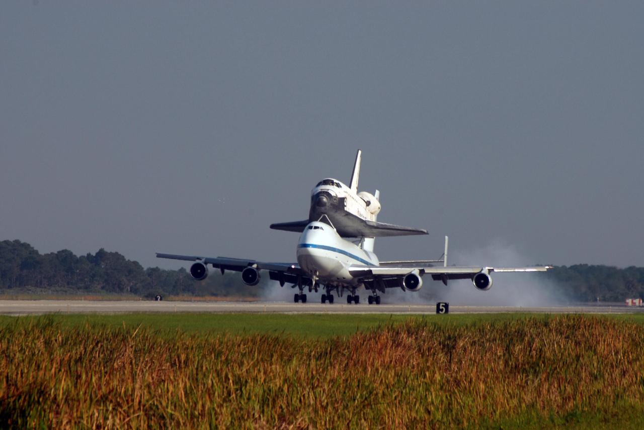 KENNEDY SPACE CENTER, FLA. -- After a three-day trip from California, the shuttle carrier aircraft, or SCA, and its piggyback passenger Atlantis kick up dust at landing on the KSC Shuttle Landing Facility runway. Touchdown was at 8:27 a.m. EDT. The SCA is a modified Boeing 747 jetliner. Atlantis landed at Edwards Air Force Base in California to end mission STS-117. The return to KSC began July 1 and took three days after stops across the country for fuel. The last stop was at Ft. Campbell in Kentucky. Weather conditions over the last leg postponed the return trip until July 3. Atlantis will be removed from the back of the SCA via the mate/demate device at the SLF. It will then be towed to the Orbiter Processing Facility to begin processing for its next launch, mission STS-122 in December. Photo credit: NASA/Ken Thornsley