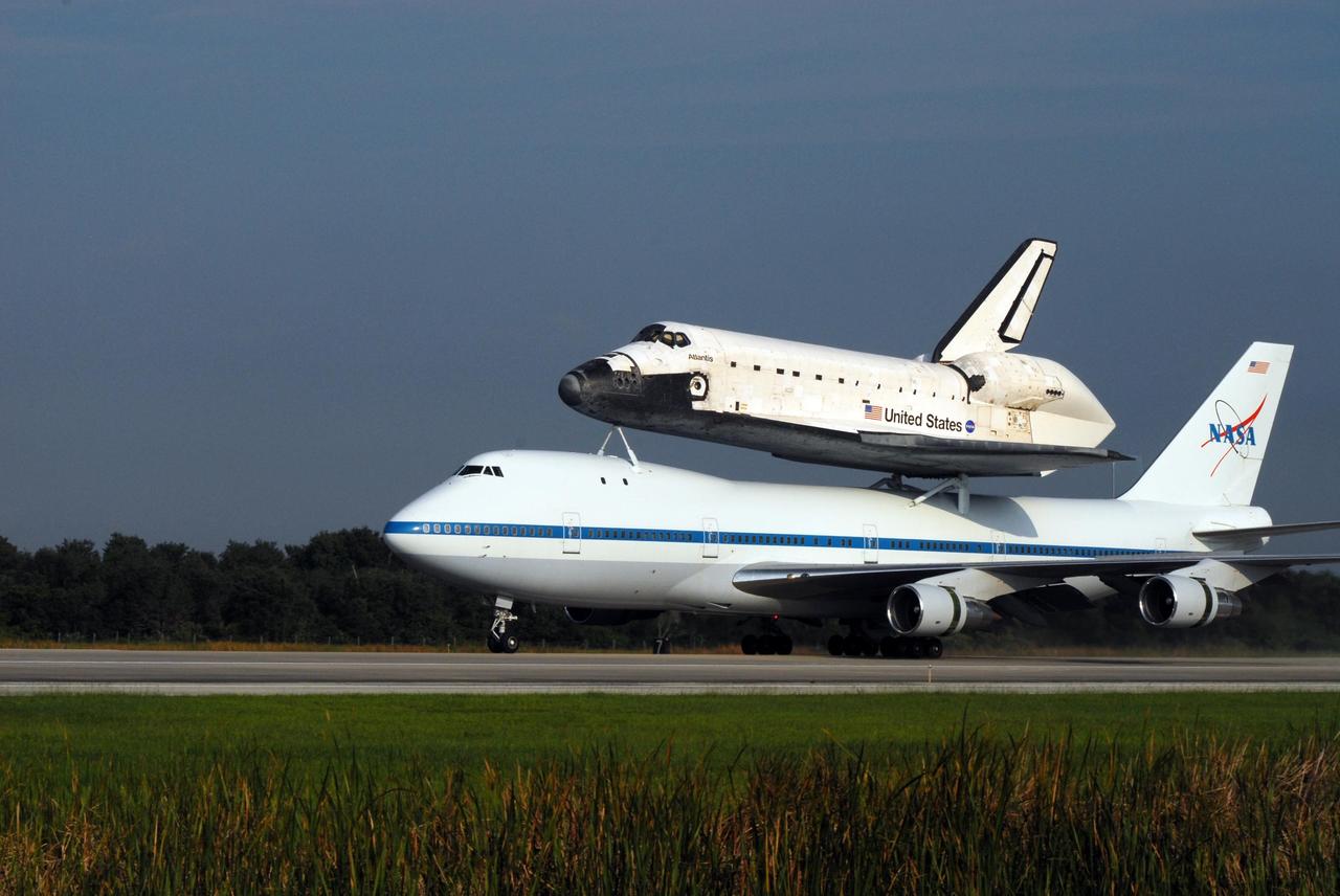 KENNEDY SPACE CENTER, FLA. -- After a three-day trip from California, the shuttle carrier aircraft, or SCA, and its piggyback passenger Atlantis land on the KSC Shuttle Landing Facility runway. Touchdown was at 8:27 a.m. EDT. The SCA is a modified Boeing 747 jetliner. Atlantis landed at Edwards Air Force Base in California to end mission STS-117. The return to KSC began July 1 and took three days after stops across the country for fuel. The last stop was at Ft. Campbell in Kentucky. Weather conditions over the last leg postponed the return trip until July 3. Atlantis will be removed from the back of the SCA via the mate/demate device at the SLF. It will then be towed to the Orbiter Processing Facility to begin processing for its next launch, mission STS-122 in December. Photo credit: NASA/Ken Thornsley