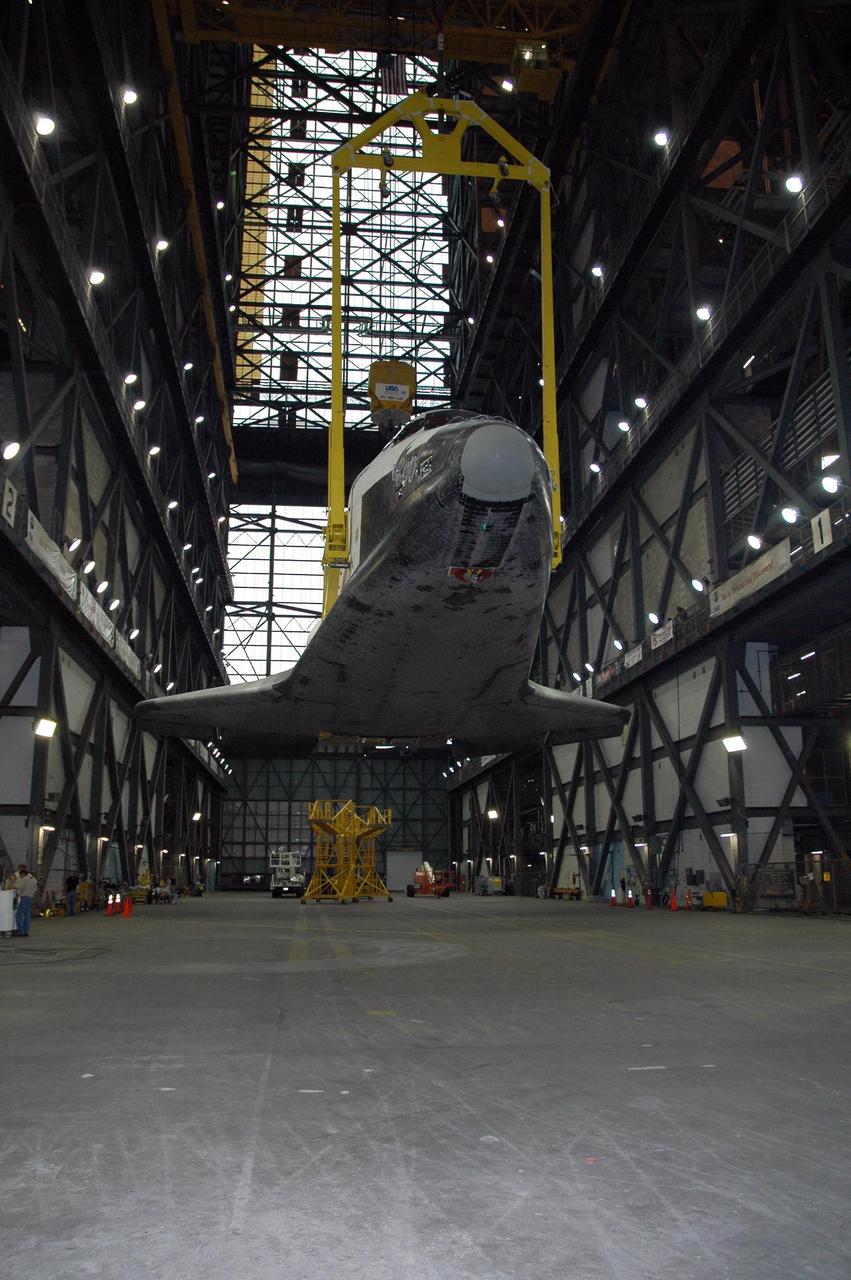 KENNEDY SPACE CENTER, FLA. --  The orbiter Endeavour hangs above the transfer aisle of the Vehicle Assembly Building.  The attached sling will raise it to vertical and lift it into the upper levels of the VAB. Then it will be moved to high bay 1 and stacked with the e1ternal tank and solid rocket boosters on the mobile launcher platform.  Endeavour will be launched on mission STS-118, its first flight in more than four years. The shuttle has undergone e1tensive modifications, including the addition of safety upgrades already added to shuttles Discovery and Atlantis. Endeavour also features new hardware, such as the Station-to-Shuttle Power Transfer System that will allow the docked shuttle to draw electrical power from the station and e1tend its visits to the orbiting lab.  Endeavour is targeted for launch on Aug. 7.     Photo credit: NASA/Charisse Nahser