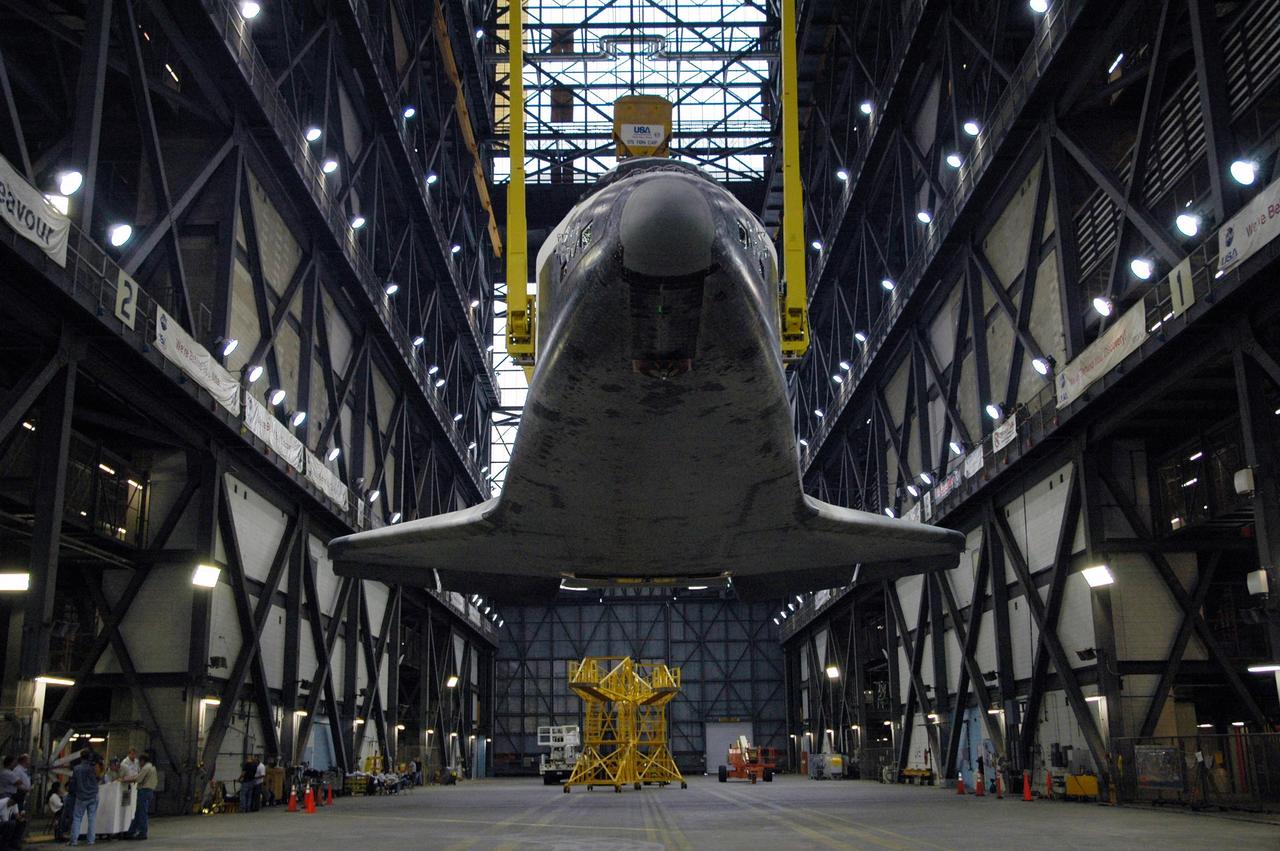 KENNEDY SPACE CENTER, FLA. -- Hanging above the transfer aisle of the Vehicle Assembly Building, the orbiter Endeavour is raised to vertical. It will be lifted into the upper levels of the VAB, moved to high bay 1 and stacked with the e1ternal tank and solid rocket boosters on the mobile launcher platform. Endeavour will be launched on mission STS-118, its first flight in more than four years. The shuttle has undergone e1tensive modifications, including the addition of safety upgrades already added to shuttles Discovery and Atlantis. Endeavour also features new hardware, such as the Station-to-Shuttle Power Transfer System that will allow the docked shuttle to draw electrical power from the station and e1tend its visits to the orbiting lab. Endeavour is targeted for launch on Aug. 7. Photo credit: NASA/Charisse Nahser
